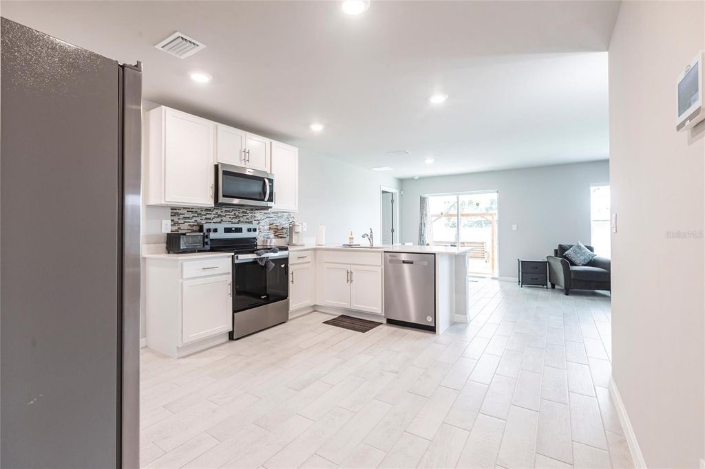 Photo of 2554 Lakeshore Circle, Port Charlotte, FL 33952 (MLS # O6330024)