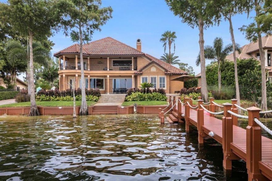 THIS IS THE BUTLER CHAIN LAKEFRONT LIVING OPPORTUNITY THAT YOU HAVE BEEN WAITING FOR!
Perfectly positioned on Lake Sheen, part of the famed Butler Chain of Lakes, this pristine and immaculately maintained custom masterpiece with a PRIVATE BOAT RAMP offers an unparalleled lakefront lifestyle.
Featured in Florida Travel & Leisure for having one of "The Best Outdoor Living Areas in Florida," the home is truly spectacular both inside and out. The first floor offers a luxurious primary bedroom retreat with custom closets, lake views, and a jaw-dropping spa-style bathroom, plus a home office, soaring-ceiling family room, formal dining room, and eat-in kitchen overlooking the zero-entry pool/spa and lakefront.
Upstairs, you’ll find three additional bedrooms and a spacious terrace with panoramic views overlooking the pool and the sparkling waters of Lake Sheen—perfect for morning coffee or evening wine.
The outdoor living and recreation areas are truly over-the-top. A pavered circular drive leads to a gated motor court and your very own PRIVATE boat ramp. The expansive dock is built for entertaining, with ample lighting, a covered boat lift, two jet ski lifts, a kayak lift, and a covered fire pit lounge. You’ll also find a built-in ladder for easy lake access and a step-down entry from the dock—perfect for swimming, floating, or launching paddleboards.
All just minutes from Tibet Butler Preserve, world-class shopping, and dining at Disney Springs, and only 15 minutes from the Disney Parks, where you’ll enjoy nightly fireworks views from your backyard. Zoned for highly rated schools, including Castleview Elementary, Horizon West Middle, and Windermere High School.
Additional features include a 40kW whole-house generator, 21 SEER Trane zoned HVAC, irrigation well, water filtration system, and state-of-the-art security.
Schedule your private showing today—this one is truly a rare find.