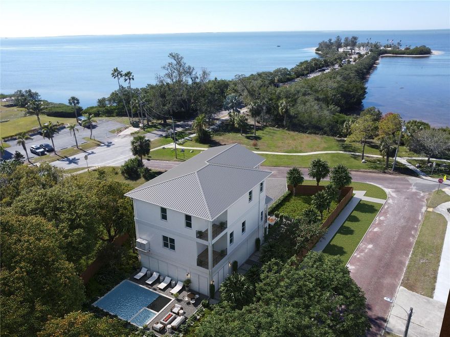 Pre-Construction. To be built. Introducing 96 Shore Drive, a waterfront masterpiece just steps from the sugar-white sands of Sunset Beach. Meticulously designed and engineered to meet the most stringent hurricane and flood standards, this three-story contemporary coastal residence features a deep foundation system, impact-rated doors and windows, and reinforced metal roofing. Spanning 3,466 square feet of air-conditioned living space (5,586 under roof), the home offers five bedrooms, three-and-a-half baths, and a spacious ground-level garage ready to accommodate multiple vehicles and golf carts.
Unwind on two upper floors of open-concept living, complete with nightly Gulf of Mexico sunsets from the comfort of your private covered  balconies. A modern chef’s paradise awaits in the kitchen, showcasing sleek quartz countertops, white oak shaker cabinetry, and a walk-in butler’s pantry. Smart home features and an upstairs laundry room enhance convenience and style, while the backyard saltwater pool invites you to savor Florida’s famous sunshine in your own private oasis.
Beyond your doorstep, explore vibrant Downtown Tarpon Springs and the Historic Sponge Docks, both teeming with local shops, fresh seafood restaurants, and year-round community events. From the beach at your feet to the cultural heart of the city moments away, this professionally designed residence delivers the ultimate blend of luxury, resilience, and coastal lifestyle. Secure your slice of waterfront paradise and discover why 96 Shore Drive is more than a home, it’s an invitation to experience Florida at its finest.