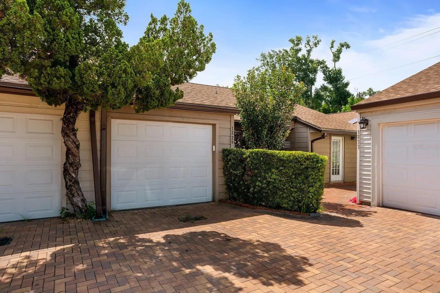 This 2 bedroom, 2 bathroom townhome offers 1,495 square feet of beautifully designed space in a highly sought-after location. Enjoy a bright living area featuring a gorgeous tiled fireplace, built-in bookshelves, and two sets of French doors that open to your private patio and fenced backyard with brick pavers and turf grass. The home includes a spacious double vanity bathroom, custom shelving for extra storage, and a one-car garage with an additional air-conditioned room behind it. Recent updates include a 2021 roof, 2022 AC, and a transferable termite bond for added peace of mind. Located just 1.5 miles from Downtown Winter Park and Park Avenue, and only a mile from the newly renovated Winter Park Village, you’ll be close to shopping, dining, and easy access to I-4 and downtown Orlando. The community also features a pond, dog park, and playground right outside your door. The HOA covers pool access, community maintenance, driveway, high-speed fiber internet, & 100+ cable channels.