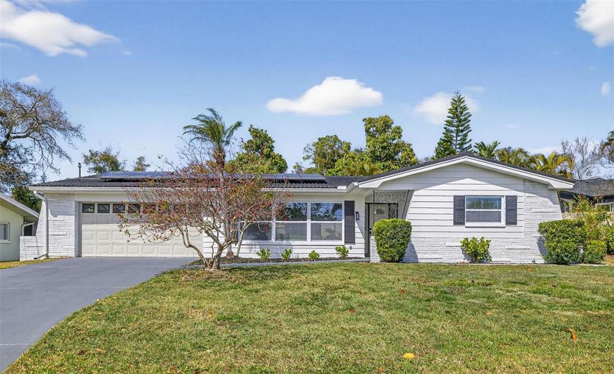 Beautifully updated 3 bedroom, 2 bath home with a 2 CAR GARAGE in HARBOR HILLS, just minutes from the water and GULF BEACHES, this stunning home blends elevated design with relaxed Florida living. From the moment you step inside, you’re welcomed by a light-filled OPEN-CONCEPT living, dining, and kitchen area that immediately showcases the home’s DESIGNER FINISHES and inviting flow.

The primary suite is a true retreat with a LARGE WALK-IN CLOSET and an incredible DOUBLE-SIDED SPA-STYLE BATHROOM. One side features a DEEP FREESTANDING SOAKING TUB surrounded by custom tile and set beneath a gorgeous CHANDELIER, while the other side offers a designer STAND-UP SHOWER with gold fixtures and custom tile. The bathroom also includes a DOUBLE VANITY WITH QUARTZ COUNTERS, combining style and functionality for a LUXURIOUS, BOUTIQUE-HOTEL experience.

The primary suite is a true retreat with a LARGE WALK-IN CLOSET and an incredible DOUBLE-SIDED SPA-STYLE BATHROOM. One side features a DEEP FREESTANDING SOAKING TUB surrounded by custom tile and set beneath a gorgeous CHANDELIER, while the other side offers a designer STAND-UP SHOWER with gold fixtures and custom tile—together creating a LUXURIOUS, BOUTIQUE-HOTEL experience.

The additional bedrooms are spacious, filled with natural light, and offer ample closet space. The secondary bathroom is also beautifully updated with a NEW DOUBLE VANITY, sleek black fixtures, and a tub/shower with CUSTOM PORCELAIN TILE.

The home also features a LARGE SCREENED-IN LANAI and sits on a HUGE LOT just under a quarter of an acre. You'll love the longevity of the CLAY TILE ROOF and SOLAR PANELS to help REDUCE ENERGY COSTS too!

Perfectly located in one of Largo’s most desirable neighborhoods, close to beaches, marinas, golf courses, dining, shopping, and everyday conveniences—this is a home that truly stands out for its style, comfort, and unbeatable coastal location.