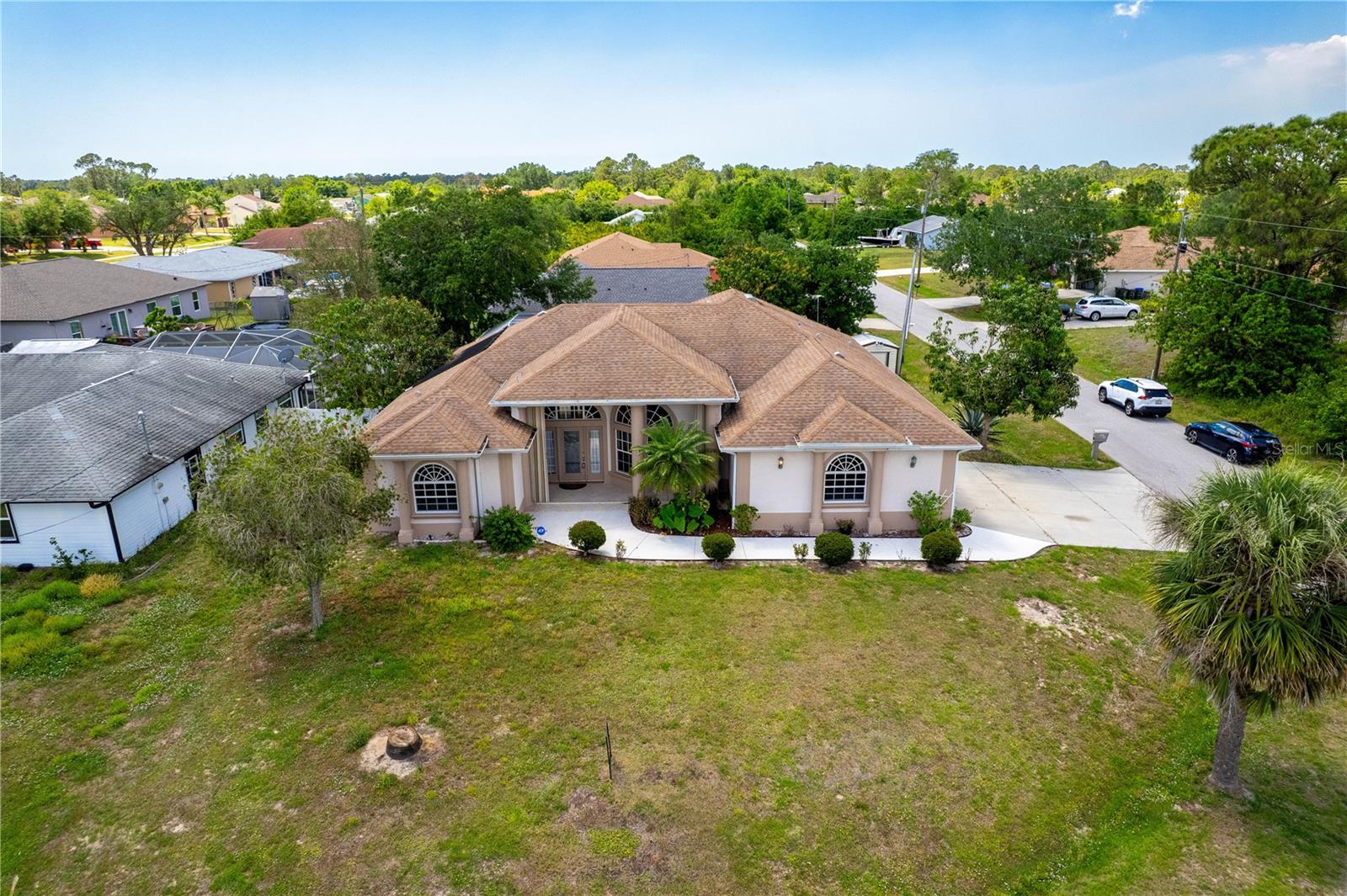 Welcome to 8315 Raoul Ave, a freshly painted 3-bedroom, 2-bath custom home situated on a generous corner lot in one of North Port’s rapidly growing neighborhoods. Step inside to discover high tray ceilings complemented by elegant crown molding, gorgeous hardwood flooring, and ample natural light throughout. The open-concept gourmet kitchen boasts gleaming granite countertops—ideal for casual meals or entertaining.
You’ll love the effortless flow into the inviting living area, which features a built-in entertainment center and custom shutters that add both style and privacy. The spacious primary suite includes two walk-in closets, a double vanity, and a relaxing Jacuzzi tub for a spa-like retreat. Outside, the screened lanai offers a refreshing pool and comfortable space for hosting or simply soaking up the Florida sunshine.
With easy-to-use accordion hurricane shutters around the home, you can lock up and travel worry-free. Located minutes from Warm Mineral Springs, the new North Port Aquatic Center, and a short drive to Manasota Beach, this residence also places you near convenient shopping and dining. Enjoy modern comfort and relaxed Florida living in this meticulously crafted, freshly updated home.