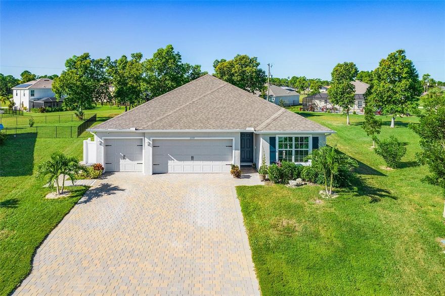Built in 2023, this stunning 4-bedroom, 3-bathroom, 3 car garage home offers modern living with every upgrade you could want. With 2,020 sq. ft. of living space, this contemporary home features modern upgrades and timeless style. Upon entering you'll find wood look plank ceramic tile throughout the main living areas, quartz countertops in the kitchen and bathrooms and stainless steel kitchen appliances. The spacious master suite features a double vanity, walk-in shower, separate toilet room and his and hers walk in closets. Step outside to your private oasis featuring a brand-new large heated pool with screened enclosure and a large paver patio—perfect for relaxing or entertaining in the gorgeous year round Florida weather. Inside, the open layout is filled with natural light, highlighted by hurricane-impact windows for peace of mind. Additional highlights include a key pad entry on the front door, a security system, and other smart home features. The owners have added a Generac whole-house propane fueled generator, making this home truly hurricane-ready. Thoughtful landscaping and a paver driveway complete the picture, offering curb appeal and a finished look from day one. Irrigation system helps keep the landscaping looking green and healthy all year round. This home is ideal for year round or seasonal residents seeking a spacious and relaxing retreat on a quiet street and large 1/4 acre lot. Close proximity to I-75, restaurants, shopping, beaches, marinas, schools, and recreational points of interest. Only 12 miles from the Punta Gorda Airport. Don’t miss this move-in ready property that blends comfort, safety, and style in one beautiful package!