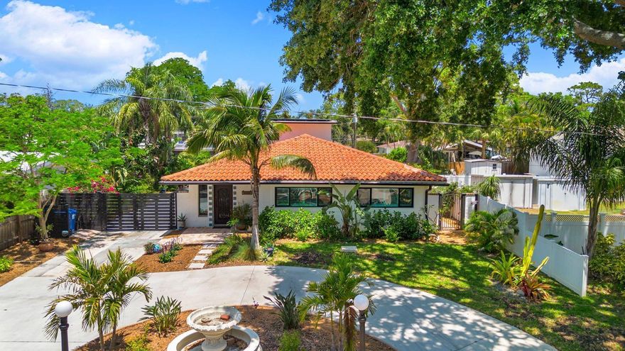 20 FOOT ELEVATION! Welcome to this exceptional 4-bedroom, 4-bath luxury residence with a dedicated office in the sought-after Pasadena Estates — a perfect haven for a growing family or a lucrative income property opportunity! Set behind a brand-new driveway gate, this home makes a statement with beautiful curb appeal, a striking centurion fountain, and a paver-lined patio and entrance. Step inside through the custom steel front door to a light-filled interior where an abundance of windows and Saltillo tile floors create warmth and character across an open, split-level floor plan. The modern kitchen is a chef’s dream, featuring an oversized island, marble backsplash, gleaming granite countertops, and brand-new stainless-steel appliances. The spacious living room flows effortlessly to a separate dining area, ideal for gatherings of any size.
A rare two-story primary ensuite offers its own private office, laundry room, generous walk-in closet, and extra storage — perfect for multi-generational living or a mother-in-law suite. Recent upgrades include a new master bath, whole-house solar system, vapor fireplace, remodeled main bath, fresh interior and exterior paint, new rain gutters, and more.
The expansive outdoor tiled patio invites alfresco entertaining, relaxing with a good book, or unwinding beneath the trees. With ample secured parking for up to 8 vehicles, plus room for a boat, RV, or even a future lap pool and spa, this property is both versatile and ready to grow with your vision. No flood zone and just moments from historic Stetson University, Pasadena Plaza, lively Downtown Gulfport, artsy Downtown St. Pete, and the powdery sands of St. Pete Beach and Treasure Island. A truly rare offering in a prime location.