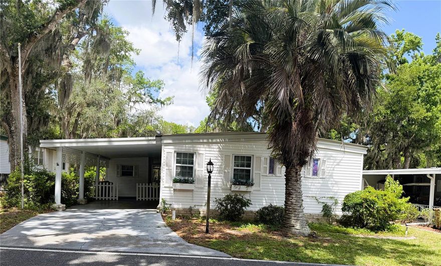 Beautiful 2-bedroom, 2-bath river view home offering 1,452 square feet of comfortable living space on the desirable Royal Palm Drive in Hawthorne at Leesburg! This well-maintained home features an open concept floorplan with an updated kitchen showcasing a large island and charming country farmhouse style. Enjoy relaxing river views from both the spacious screen room and the Florida room, creating the perfect setting for morning coffee or evening sunsets.

The home offers laminate flooring throughout the main living areas, tile flooring in the Florida room, and carpet in the guest bedroom. Both bedrooms feature walk-in closets for ample storage. The main bedroom includes a walk-in shower, while the guest bath offers a convenient tub/shower combination. Updated windows allow for plenty of natural light and energy efficiency.

Outside, the large backyard provides beautiful river views along with mature shade trees and room for golf cart parking. Additional features include newer washer and dryer, inviting outdoor living spaces, and a peaceful setting that makes this home a true retreat.

Hawthorne at Leesburg is a vibrant 55+ community that blends comfort, convenience, and affordability. For just $397 a month, residents enjoy a maintenance-free lifestyle that includes water, sewer, lawn care, emergency services, and access to a wealth of resort-style amenities plus secure RV and boat storage. The expansive clubhouse is the social hub of the community, offering over 100 organized activities, a welcoming lounge, card rooms, billiards, a fitness center, a library, and a fine arts studio. A dedicated program coordinator ensures there’s always something fun and engaging on the calendar.

For those who love the water, the private marina has 120 boat slips with direct access to the beautiful Harris Chain of Lakes. Safety and peace of mind come standard thanks to a 24/7 on-site team of state-certified firefighter/EMTs, emergency vehicles, and in-home emergency response buttons. Surrounded by natural beauty, the community features scenic walking trails, serene lake views, and plenty of opportunities for fishing and boating. The golf cart-friendly streets make it easy to explore nearby shopping, dining, and medical facilities. With a sparkling pool, endless recreational options, and a warm, welcoming atmosphere, Hawthorne at Leesburg isn’t just a place to live — it’s a lifestyle. Schedule your showing today!
