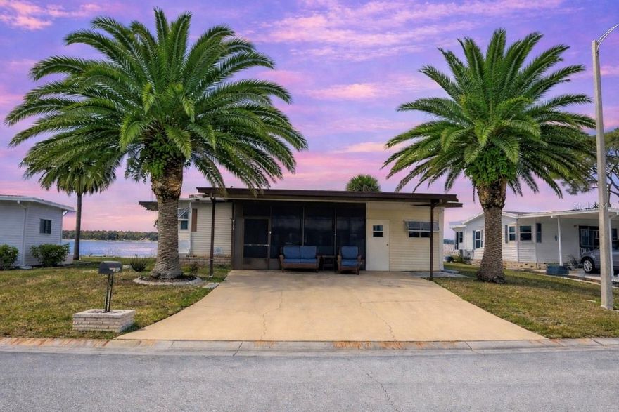 A peaceful lakefront escape framed by spectacular sunset skies. Updated, modern turnkey home offered furnished and move-in ready for immediate enjoyment. Perfectly situated on Lake Imperial in the premier 55+ community of Harbor Cove. This home offers unobstructed, panoramic views of Lake Imperial and is just a short distance to the clubhouse and pools. Features: Roof 2023 All Weather Roofing: Membrane, Windows 2017, Kitchen Water Filter and Faucet 2025, Newer Floors. The spacious sunroom is a true highlight of the home, offering breathtaking sunset views over Lake Imperial. Filled with natural light, this inviting space is perfect for morning coffee, relaxing with a book, comfortably hosting overnight guests, or entertaining while enjoying serene water views and colorful evening skies. Generous extra-wide driveway allows for convenient parking for multiple vehicles and guests. Large primary bedroom featuring an ensuite bathroom and dual closets. Spacious guest bedroom with ample closet space. City water and sewer. NO LOT rent. Low monthly HOA fee of just $175 a month! Includes access to two sparkling heated pools, a relaxing spa, a well-equipped fitness center, a clubhouse overlooking the stunning marina, shuffleboard, horseshoes, pickleball, tennis, and bocce courts. Socialize and stay active with dances, parties, water aerobics, fitness classes, art classes, woodworking, golf cart parades, bingo, dances, and
more. Boat clubs, a craft room, picnics on the patio, golf clubs, bowling clubs and much more. Community Boat Ramp with Access to the Myakka River that runs into the Gulf of America. There is plenty of wildlife to enjoy in this 190-acre community; herons, egrets, cranes, ibis, parrots, even alligators and manatees! Conveniently located within minutes of Downtown Wellen Park, Costco, shopping, restaurants, and a short drive to beautiful Gulf Beaches. Schedule a viewing today and let this dream home become your reality!