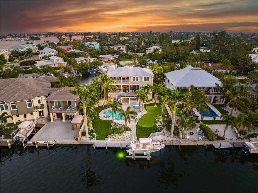 ANNA MARIA LIVING AT IT'S FINEST. This remodeled and redecorated 4 bedroom, 3 ½ bath home is perfectly located on the island. Open concept living, dining, kitchen and patios are featured on the main floor. Upstairs the primary master flows out onto another patio but also has a large luxury bath and walk-in closet. You quickly realize this house is one house from the end of the canal so you can have easy access to Bimini Bay and beyond or take a quick stroll to watch the sunsets from the powder soft sand beaches of Anna Maria. Outdoor living is what this house is known for with two large decks, a roof top deck that you can see for miles from or the fun backyard which features a putting green, outdoor kitchen and a resort style pool. Bright and open coastal living is the best way to describe the inside with a very large island with seating and a dining area that you can watch the boats go out. With Water views in the front, the back and 360 degrees upstairs there are many places to see what island living is like. Updated appliances & furnishings, new outdoor decking for the patios, and it is being sold turnkey furnished. As you can imagine if you are interested, the rental potential here is phenomenal and there is a management company and rentals in place. If you are ready to enjoy luxury island living and to explore all the surrounding waters have to offer, this is the one and only home for you.