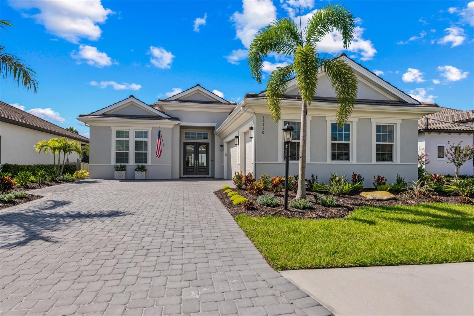Luxury living within the gates of the highly sought after resort community of Esplanade at Azario in renowned Lakewood Ranch. Don’t miss this extremely rare opportunity to own a no longer available Lincoln model on a deeded golf inclusive homesite featuring a south facing lanai and unobstructed golf course and water views. As you step through the grand glass double doors, you’re welcomed by soaring 13 foot ceilings. Stunning Carrara 24in x 24in tile covers the entire home creating a bright, elegant, and cohesive look. To your right, is a formal dining room complete with tray ceilings accented with a stunning designer chandelier. A custom wet bar with dual zone wine refrigerator, custom floor to ceiling mirrors, and glass bar cabinetry complete the space. An entertainer’s dream, the open floorpan flows beautifully through the butler's pantry to the chef’s kitchen. Fully equipped with upgraded GE stainless steel appliances, 5 burner gas stove, glass upper cabinets, under cabinet LED lighting, double wall ovens, quartz Cambria countertops, and top mount built-in refrigerator/freezer are just a few of the many upgrades in this kitchen. Relaxing and open, the expansive great room features a captivating fireplace for chilly evenings with pocket sliding glass doors leading out to the impressive travertine covered outdoor living area. Gather with friends by the outdoor gas fireplace, dine al fresco with a meal prepared at the custom outdoor kitchen, or lounge by the pool soaking in the views through the panoramic pool screen. When it’s time to cool off, take a dip in the saltwater pool with LED lighting, sparkling glass tile, multiple waterfalls, and a magnificent 8ftx12ft raised infinity spa. Both spacious guest rooms are elegantly appointed, each featuring a full bathroom with floor to ceiling tile and quartz Cambria countertops. Private from the guest suites, the master bedroom is truly a retreat with huge windows framing the room allowing light to pour into the space. A gorgeous ensuite bathroom with an enormous shower featuring floor to ceiling highest level tile and not one, but two custom built-in closets make this home an ideal layout. Off the main living area, the den provides yet another area to lounge with French doors for privacy. Esplanade at Azario features an 18 hole golf course, pro shop, culinary center, fitness center, full service spa, multiple tennis and pickle ball courts, coffee shop, resort pool, and Bahama bar and restaurant. Lakewood Ranch is centrally located to fabulous dining, shopping, and world class gulf coast beaches. Don’t hesitate, book your showing today.