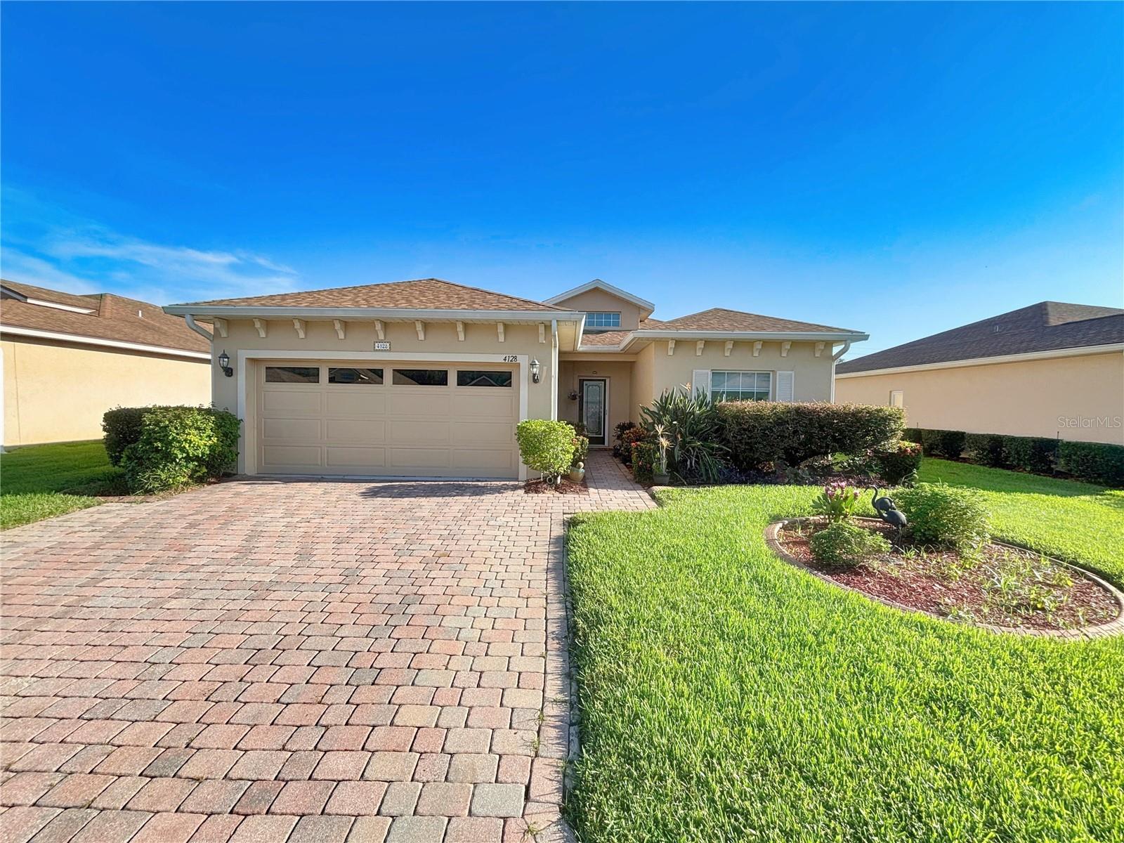 4128 Aberdeen Lane, Lake Wales, Florida is a 2 Bedroom/2 Bath move-in ready ESSEX floor plan home. This home is located on a lot that abuts a pond. Upon arrival the curb appeal is evident. Quality landscaping and various plantings, and awnings on the side of the home. The welcoming foyer is bathed in natural light from the over-the-transom window and from the leaded glass front door. The foyer has ceramic tile flooring. The foyer is where access to the second bedroom/guest area is located. A handy pocket door can be used to isolate the entire guest area from the rest of the home. The ample-sized second bedroom has a ceiling fan and a built in closet. The hallway that connects the guest bath to the guest bedroom also has a linen closet. The guest bath has a walk in tub with a ceramic tile. The foyer opens to the den on the right; the dining, primary suite and living room straight ahead; and the kitchen to the left. The den has a double bi-fold door for privacy, a ceiling fan and the space can also provide for guest sleeping. The large window brightens up this den/home office. The flexible dining area makes entertaining easy. The primary suite includes a large bedroom area, a walk-in closet and a primary bath. The primary bedroom has a ceiling fan and a double slider to the covered and screened lanai. The primary bath has a huge walk in shower with ceramic tile, shower door, comfort height vanity with two sinks, ceramic tile flooring. The kitchen has ample cabinetry with lots of counter space. The kitchen has space for a bistro table and two chairs. The built in closet in the kitchen is the perfect place for the pantry and additional refrigerator. There is a reverse osmosis system in the kitchen. The living room is at the rear of the home and has a triple slider to the screened lanai with awning. The bedrooms, dining area, and living room have neutral carpeting. Just outside the screened lanai is a small paver area, large enough for two chairs. This patio is a great place to enjoy the pond while enjoying the famous Florida weather. Additional improvements include: interior was painted August 2025, solar hot water heater, the roof was replaced in Nov. 2022, the solar panels that service the home were installed in Feb. 2023 and the debt owed on the SOLAR PANELS will be paid in full by the SELLER at the time of CLOSING. The microwave was replaced in 2021 and the GE Dryer was replaced in 2022. The A/C is 3 years old and has a warranty that covers parts and labor until 2030. The awning on the patio was replaced in 2022. The washer and dryer stay for the new owners. Also in the kitchen is the doorway to the attached 2-car garage. The garage has a service door, a window, and attic access. 4128 Aberdeen Lane Lake Wales, Florida is located in Lake Ashton, a Florida Retirement community. Lake Ashton has 2 18-Hole Golf Courses, Clubhouse with Movie Theater, Bowling Lanes, Grand Ballroom, Restaurant, Card, Craft and Billiards, Fitness Center and outdoor temperature controlled pool. Bocce Courts, Tennis Courts, Screened Pavilion with Gas Grills are located just beyond the Clubhouse. Residents also enjoy the Eagles Nest, another eating venue, along with an On-Site Pro Shop. The Health & Fitness Center is an amenity residents enjoy. It has a large multi-purpose room, indoor pool, indoor 1/2 court basketball, indoor racquetball, card, craft and billiards, pickleball and tennis courts.