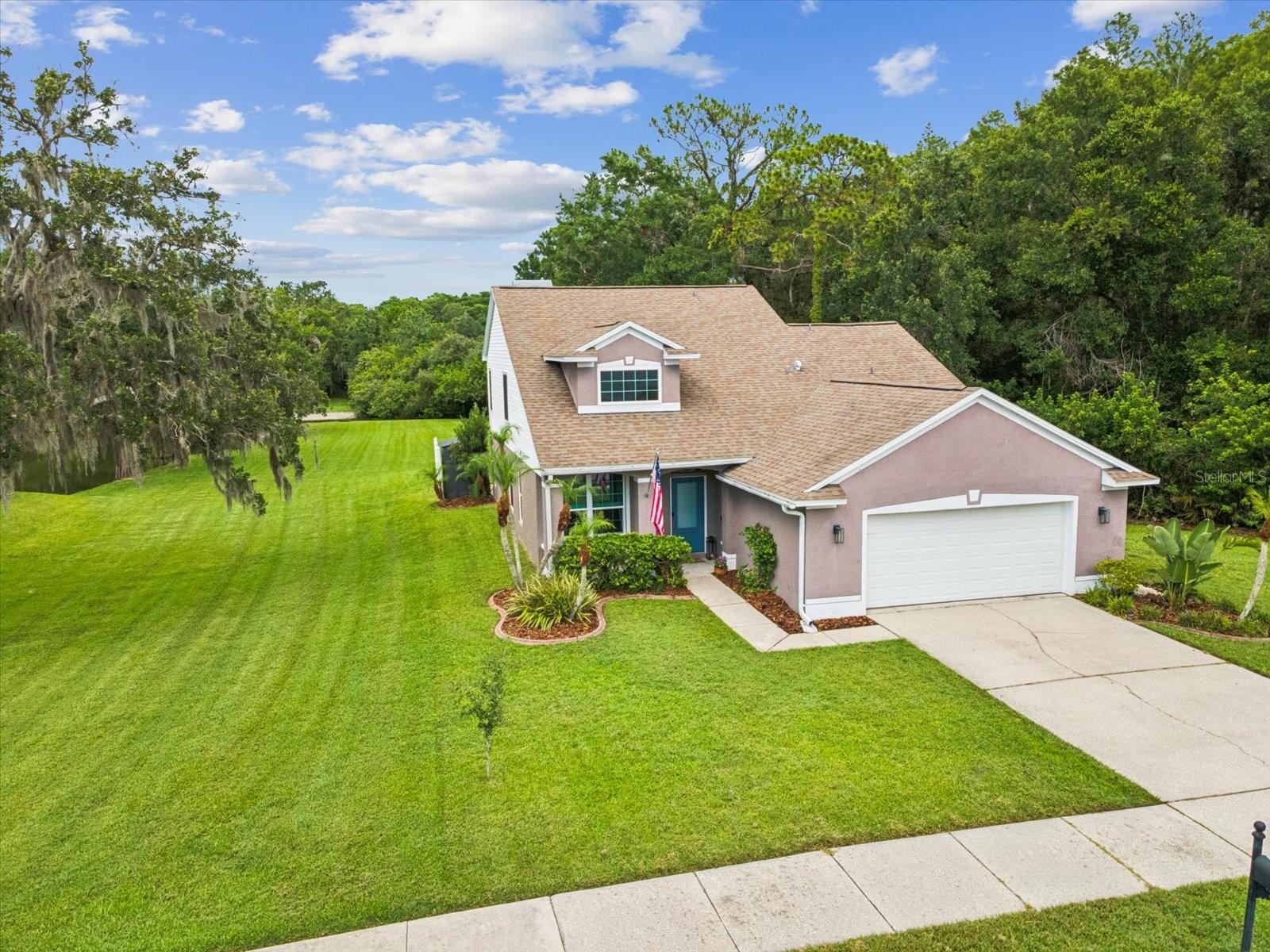 This Oldsmar home offers a rare combination of privacy, thoughtful upgrades, and an unbeatable location. This 4-bedroom, 2.5-bath home sits on a premium conservation lot with no rear or side neighbors and features a beautiful water view of the large pond just beyond the backyard—creating a peaceful and private retreat surrounded by nature. Inside, the home has been beautifully updated with quartzite kitchen countertops, a new sink and hardware, and a stylish subway tile zellige backsplash. Engineered hardwood flooring flows throughout the main living areas, and the primary bathroom features elegant travertine tile. The home is loaded with major upgrades that add both comfort and long-term value. PGT hurricane impact windows were installed in 2018, along with an impact glass front door in 2019. A new water heater was added in 2023, and a whole-house HEPA filter system was installed in 2024. The HVAC system was replaced in 2016 and remains in excellent condition. For eco-conscious buyers, the garage has EV charger hookup capability, and there's a reclaimed water hookup added in 2022 for efficient irrigation. Smart home features include Nest carbon monoxide and smoke detectors on both floors, a Ring camera, and smart locks on the garage and front doors. Located in a quiet, sought-after neighborhood close to top-rated schools, parks, shopping, and an easy commute to Tampa or the Gulf beaches, this move-in ready home offers the lifestyle and upgrades today’s buyers are looking for. If you're seeking privacy, modern finishes, and long-term peace of mind—this is the one.