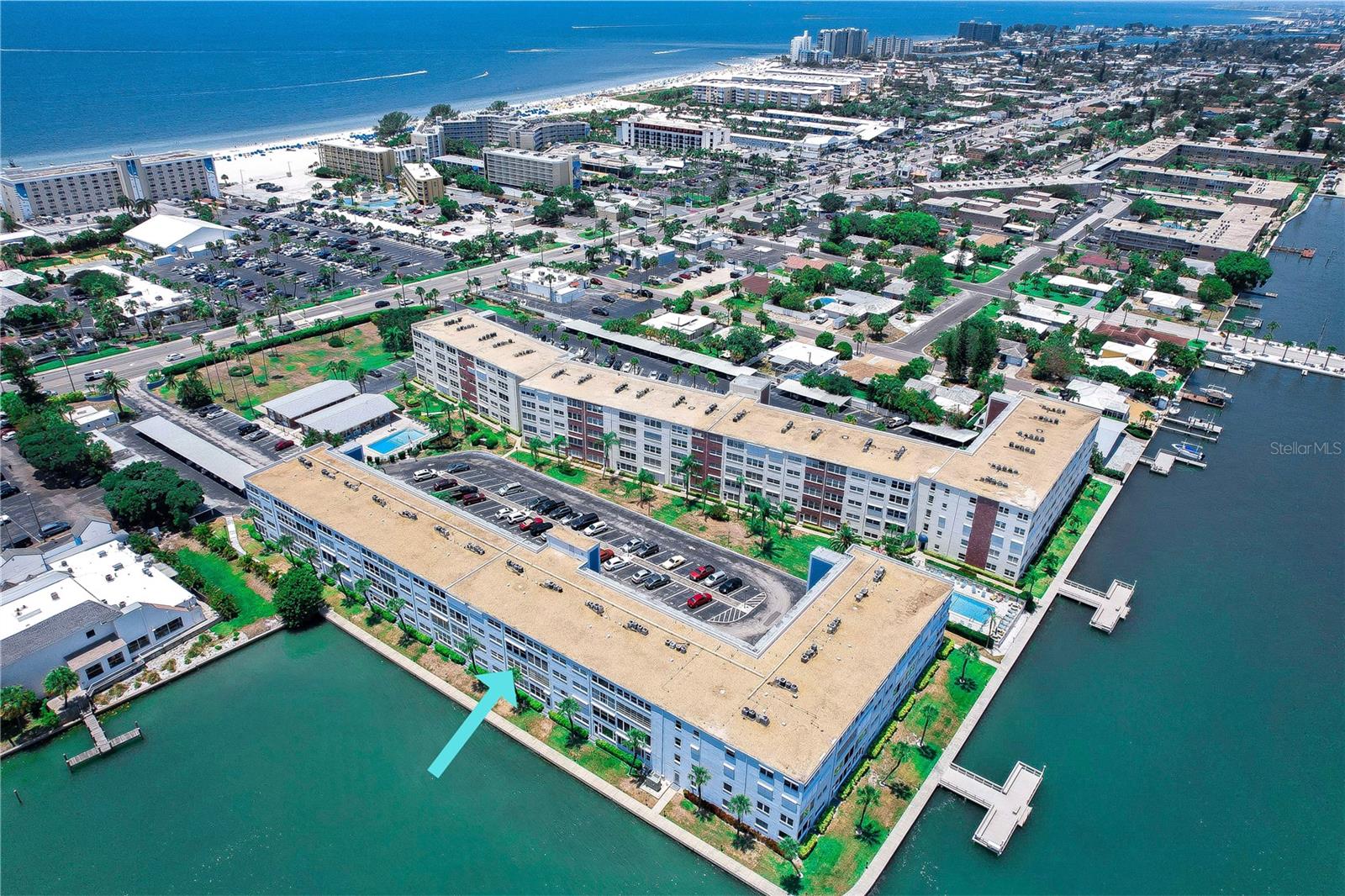 Waterview! Don't miss out this second-floor 2-bedroom, 2-bath condo situated across the street from beautiful St Pete Beach. With a wide open, spacious living area and a range of amenities, this unit provides an excellent opportunity for beach living. This beautiful home boasts a dining area and a living room that seamlessly transitions into a bonus sunroom offering sparkling water views of Boca Ciega Bay. The bedrooms in this condo are generously sized and feature large walk-in closets. The desirable split bedroom floor plan ensures privacy for both the family and guests. The owner's suite boasts water views and a beautifully remodeled en-suite bathroom with a walk-in glass shower. Upgraded vinyl flooring has been installed throughout the main living areas and bedrooms, adding a touch of elegance. In the evenings, you can step outside your front door and relax on the community veranda on the second floor. Alternatively, you can enjoy your 13'x9' sunroom, which offers a spectacular view of the changing colors of the sky. The unit comes with one assigned carport parking spot and an additional locked storage area. Laundry rooms are conveniently located on every floor. Regency West, the waterfront community where this condo is located, offers an array of amenities. Residents can enjoy two pools, a clubhouse with pool tables, a fitness room with a sauna, shuffleboard courts and a picnic area with barbecue grills. The community provides a truly enjoyable living experience. The condo's location is a five minute walk to the waters of St. Pete Beach. Additionally, it is conveniently close to the interstate, Fort DeSoto National Park, Tampa, St. Pete/Clearwater airports, and the highly desirable Downtown St. Petersburg. With its ideal setting and various attractions nearby, this condo offers the best of beach living. Hurry! Won't last.