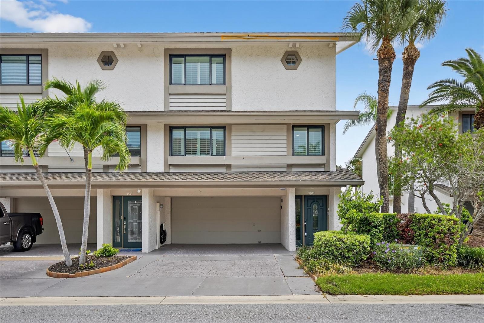 BRING YOUR BOAT AND YOUR LOVE FOR COASTAL LUXURY! This end-unit waterfront townhome in the sought-after Marina Del Rey community on Sand Key offers the ultimate Florida lifestyle with breathtaking open water views and direct boating access. Completely renovated with elegant coastal finishes, this spacious home spans three levels of versatile living space. First Floor: A flexible bonus room (ideal as a boat room, game room, or guest retreat) features a wet bar, full ensuite bath, and sliding doors to a private patio with backyard and dock access. Second Floor: Drenched in natural light, the main living level boasts a designer kitchen with white shaker cabinetry, waterfall-edge island, gleaming countertops, and top-of-the-line stainless appliances. A home office/bonus space (potential 4th bedroom) and a stylish half bath are nearby. The open dining and family rooms are wrapped in windows showcasing stunning views of the Intracoastal and marina. Third Floor: The luxe primary suite offers a private waterfront balcony, a massive walk-in closet with custom built-ins, and a spa-style ensuite bath featuring double vanities and a dramatic wet room with soaker tub and shower — all with water views. A second light-filled bedroom includes a large closet and updated ensuite with a walk-in shower. Additional highlights: Hurricane rated windows and doors. Plantation shutters, custom blinds, and electric custom blinds. Spacious laundry room, Abundant storage. New HVAC and mini split unit installed in 2024. Boaters will fall in love with the double dock with sundeck, 20,000 lb boat lift, 2 jet ski lifts, kayak lift, and TREX decking with dual-side boat access — all right in your backyard! Enjoy the heated community pool! All of this just across the street from the beach, near Sand Key Park, and a short walk to restaurants and boutiques. This is coastal living at its finest — don’t miss your chance to own a slice of Sand Key paradise!