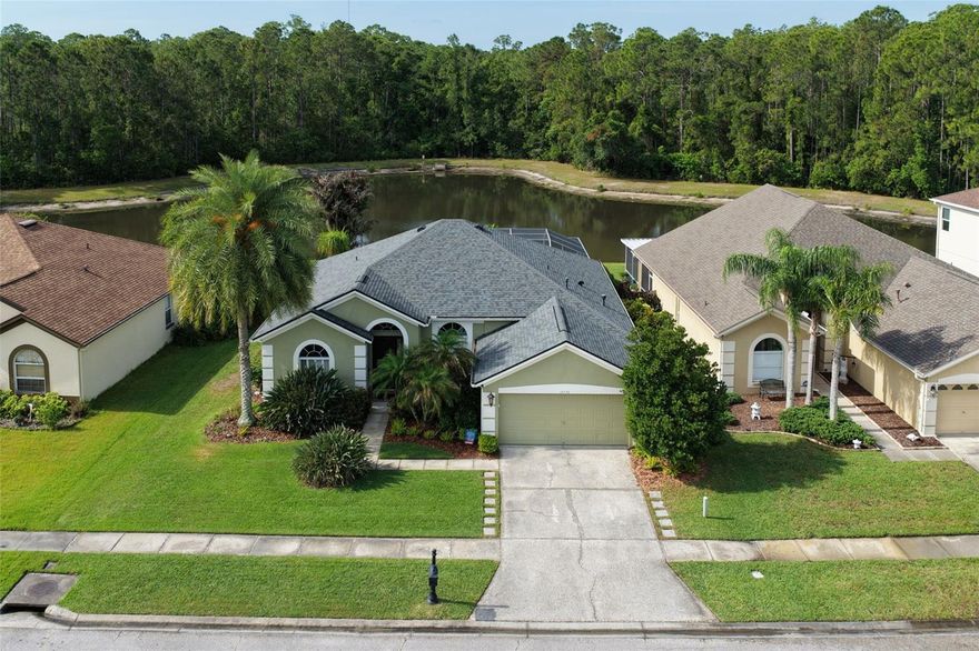 CONSERVATION & POND 4BR/2BA/POOL-SPA/UPGRADED home for sale in WESTWOOD LAKES! "Impressive" is the key word! This home has solid hardwood floors throughout & tiles in the wet areas (no carpets). Views of the lush conservation, pool/spa, & pond will greet you right upon entrance! Enjoy double walk-in closets in your spacious primary bedroom that also opens to the 4th BR/den/office. Your large living room area overlooks the stunning views & entertains as the central area of the home that includes a solid wood cabinetry, island bar for high-top stools, high ceilings, & eating space in the kitchen as well! Balanced split-plan bedrooms 2, 3, & 4 are good sizes & guests/family have a full second bathroom to enjoy! A dedicated laundry room is a wonderful treat complete with additional storage! Your garage has added improvements with two ceiling storage racks & a water softener system. You'll be most impressed with the NEW interior pool finishes ('25), Jandy Flo-Pro pool pump('25), Jandy Pro Series Tru-Clear salt generator ('25), Jandy JXIQ gas pool heater ('24), & Pentair Filter ('25). Other notable dates to home: ROOF ('22), glass enclosures to bathrooms ('26), & HVAC ('19). The back yard setting is second to none in the 33626 communities! Relax & entertain away - under your covered patio area, screened pool cage, deck areas for "fun in the shade & the sun" & fenced in yard! This home is within the desirable Flood Zone X (non-mandatory flood requirements). Be sure to look at the 3-D TOUR to see the full layout/specs of the home and features!  Westwood Lakes is a well-planned neighborhood known for its scenic conservation views, beautiful lakes & ponds, mature palms & trees, abundant wildlife, & wide sidewalks perfect for evening strolls & biking throughout the community. Residents enjoy a community park featuring combination pickleball & tennis courts, a playground, & covered pavilion—all with low HOA fees & no CDD fees, helping keep ownership costs affordable. Westwood Lakes also offers natural gas service & reclaimed water for irrigation. Centrally located, Westwood Lakes is just minutes from the Veterans Expressway, grocery stores, restaurants, shopping, public libraries, & everyday conveniences. Tampa International Airport is approximately 20 minutes away, while some of Florida’s award-winning Gulf beaches are within about 30 minutes. The community is also zoned for some of the top-rated elementary, middle, & high schools in the Tampa Bay area. With its natural beauty & convenient location, Westwood Lakes offers exceptional Tampa Bay living.