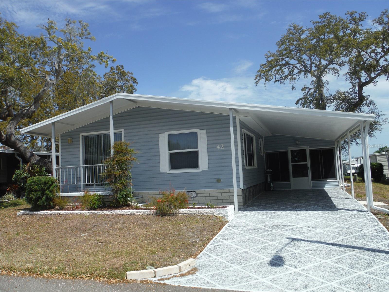 Immaculate , clean as a whistle property in the area that allows a cat or a dog up to 25 pounds. This property is impeccable! Roofover replaced March 2025. Newer vapor barrier cost approximately 5K. Newer water pipes, carpet, water heater, fridge, washer, led pocket lights on the dimmer in the kitchen & master bathroom, and privacy rolldown shades on the lanai. Everything in the home is to go with the price of the property. There is a skylight in the family room you will notice immediately as you enter the house. Water softener is owned and the bill to maintain it is $20/Month. Electric bills average approximately 200/Month. The shed is huge. There are no large trees around the house. The deeded lot 55X80 is included in the price of the house. Maintenance fee is $223/Month and includes water, sewer, trash, lawn, private roads, clubhouse, heated pool & spa, shuffleboard and a laundry room in case your appliances break. Room measurements approximate.