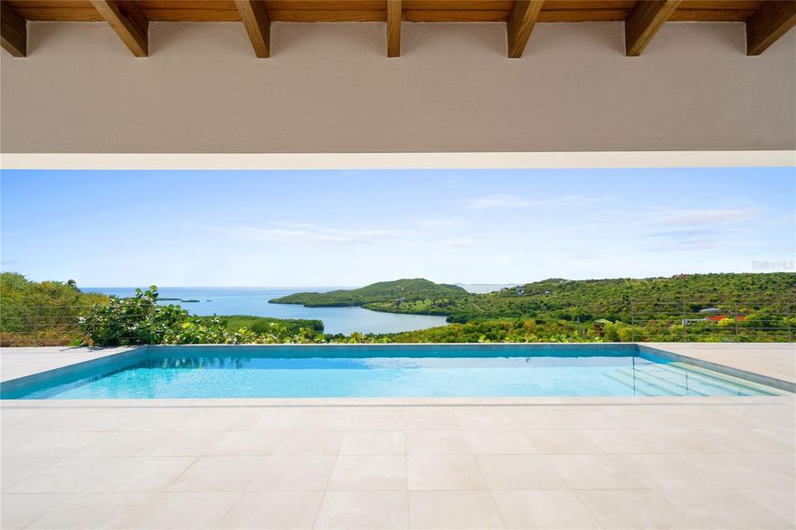 Designed to embrace the island’s natural beauty, Casa Las Pelás welcomes you with light filled living spaces where panoramic ocean views unfold the moment you arrive. The endless horizon becomes an integral part of the home, shaping how each space is experienced from the very first step inside.

Elevated above Las Pelas Bay, this residence designed by architect Pedro Rodríguez Flores offers a rare balance of openness and privacy. The living room opens directly onto an expansive terrace that forms the heart of the home, creating a seamless flow between indoor living and open air spaces ideal for entertaining, relaxation, and quiet moments.

Vaulted ceilings enhance the home’s airy atmosphere, while both the living areas and all bedrooms connect effortlessly to the outdoor living spaces, where an infinity pool overlooks the ocean, inviting you to unwind as you take in the views, feel the ocean breeze, and listen to the surrounding sounds of nature.

The two primary suites, both located on the main level, enjoy the same commanding ocean views and are designed as equal retreats. Each features a beautifully appointed en suite bathroom with an interior shower, complemented by an additional private outdoor shower, offering a daily ritual that encourages disconnection from everyday life and a deeper connection with the natural surroundings. A third bedroom on the lower level provides flexibility for guests or family, while maintaining the home’s sense of privacy and comfort.

Set on five acres of pristine land, Casa Las Pelás offers a level of space and privacy rarely found in Culebra. Designed for long term comfort and resilience, the home is connected to municipal power and water, and is complemented by a backup solar energy system with 52 solar panels and three Tesla batteries, along with a 50,000 gallon water cistern. A 120 foot community dock offers easy access for boat owners and island hopping enthusiasts.

Casa Las Pelás is a refined tropical retreat defined by privacy, autonomy, and an uninterrupted connection to the horizon.