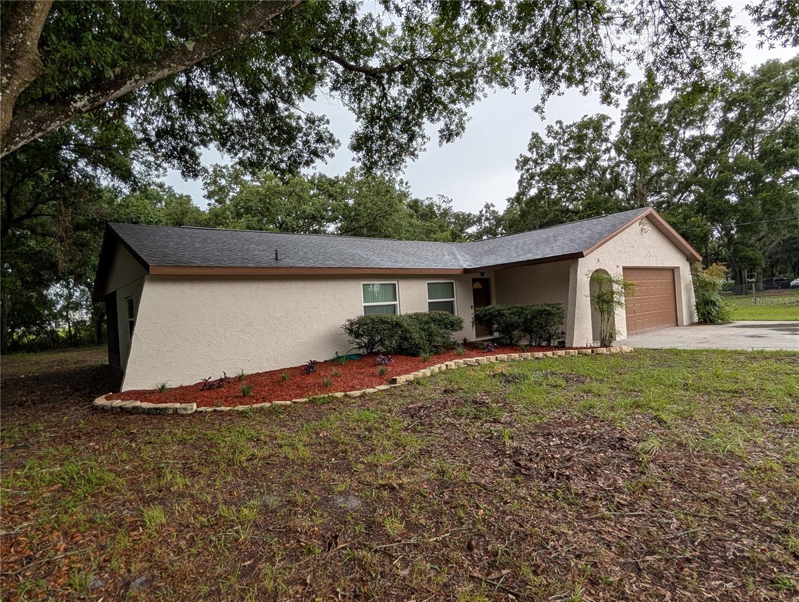 AN OLDIE AND A GOODIE!! BRING YOUR BOAT, YOUR RV AND YOUR ANIMALS, NO HOA!! This 3 bedroom, 2 bath, split floor plan home shows pride of ownership, with updated Hurricane doors and windows, a new roof (2024), remodeled kitchen with upgraded slow close cabinets, granite countertops, the same in hall bathroom and brand new carpet throughout. Both the family room and the dining room have Hurricane sliders, in the spring you can open all the doors and windows for an amazing cross breeze. There is a 50 amp breaker located on the side for your RV, and a two car attached garage with washer and dryer hook-ups. Home also has a large screened lanai in the back with lights, wet bar/mini sink, ceiling fan, and an additional concrete patio for your bar-b-q grill or maybe a little pool for the fur babies. Out front you have a covered patio/foyer to the front door which is nice protection from the rain, a massive concrete driveway with an additional parking area, plenty of room to fit ample cars or toys, a private light pole and a huge front yard so you are not too close to the road. The mature oak trees are beautiful, giving amazing protection and shade, the house is nicely centered on this acre of land to keep privacy at it's maximum and there is an easement along the rear of the property so you wont have to worry about loosing your privacy out back either. Properties like this do not pop up often in this quiet neighborhood full of beautiful homes, just far enough away from the city, but not too far from shopping, the beaches and the airport. There is nothing like these amazing well built Florida homes and this one is priced to sell.
Buyer responsible to verify information, including but not limited to; school district, animal restrictions and room sizes.