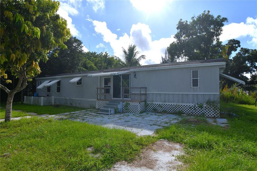 Situated in South Punta Gorda Heights and nestled on an 8,150 square foot freshwater canal lot, this 1991-built single-wide mobile home offers the perfect blend of comfort and convenience all while needing a bit of TLC to unlock its full potential.  With 924 square feet of living space, the home features a bright and airy great room design, complemented by a spacious master suite, two additional cozy bedrooms, and two full baths—ideal for family living or hosting guests.  The interior boasts a tasteful mix of ceramic tile and laminate flooring, providing a stylish yet functional atmosphere. Step outside to enjoy the expansive 41’ x 12’ covered and screened rear lanai, perfect for relaxing with a morning coffee or entertaining friends. Additionally, a 13’ x 10’ utility building under-roof provides ample storage for all your needs. Location is key! Just 2 miles from shopping and Interstate 75, and a mere 6 miles from the charming historic downtown Punta Gorda, you'll have easy access to dining, entertainment, and beautiful waterfront parks.