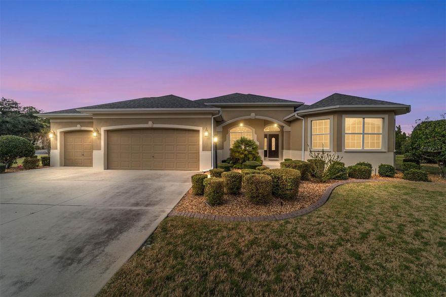 One or more photo(s) has been virtually staged. MOVE in READY: * NEW ROOF: 2025 * HVAC: 2026 * HWH 2026 * Welcome to refined Florida living in this stunning WILLIAMSBURG model PREMIER home located in The Villages, within the highly desirable Village of PENNECAMP. Perfectly positioned on a beautifully landscaped corner lot at the end of a half cul-de-sac, this block-and-stucco residence offers privacy, curb appeal, and a peekaboo view of LAKE MIONA.
Step through the expansive foyer and immediately appreciate the home’s luxury and elegance, highlighted by round architectural pillars and a spacious open layout. The living room features a tray ceiling, enhancing the sense of volume and sophistication; ideal for both entertaining and everyday living.
The kitchen is as functional as it is beautiful, showcasing solid wood cherry cabinetry with a wine rack, black granite countertops, and stainless steel appliances, with the same rich granite and cherry cabinets thoughtfully carried into the bathrooms for a cohesive, upscale design.
Flooring has been carefully curated throughout the home: large square tile spans the main living areas and lanai, while engineered hardwood floors add warmth and comfort to the primary bedroom and both guest bedrooms. Split bedroom floor plan designed for privacy; featuring two guest bedrooms with a shared bathroom on one side of the home, while the spacious primary suite is privately situated on the opposite side; ideal for homeowners and visiting guests alike
The enclosed lanai features Florida-style ceiling-height sliding windows with screens, creating a versatile space to relax and enjoy the peaceful outdoor setting year-round.
Additional highlights include a two-car garage plus a dedicated two-golf-cart garage, offering ample storage and convenience.
This exceptional home combines premium construction, elegant finishes, and a coveted location; a true showcase property for those seeking luxury living in The Villages.
* NEW ROOF: 2025 * HVAC: 2026 * HWH 2026
Be sure to watch the VIDEO TOUR @ https://youtu.be/oaMNX4vWeQ0