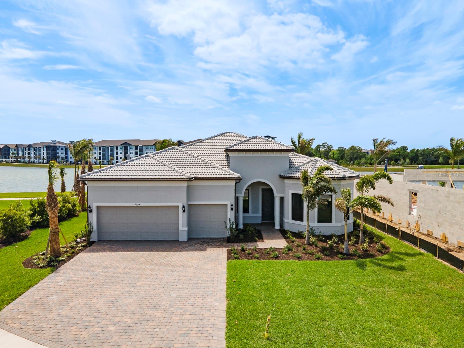 2024 Newly built WATERFRONT POOL home in Shoreview, a luxury community within Waterside Lakewood Ranch! The NEWEST, fast developing and BOOMING Premier area to be! Private waterfront lot within minutes to all the amazing Restaurants, Shopping, Events and Marina that Waterside provides. Spacious split floor plan layout that includes a FLEX/DEN ideal for an office or game room. State of the art appliances and finishes throughout the home. The owner's suite has beautiful lake views to greet you in the morning, large walk-in closet and spacious en-suite bathroom. Secondary bedrooms both have their own bathroom and walk-in closet. The lanai features a heated pool, outdoor kitchen and covered area to enjoy your morning coffee or dinner outside. You'll also find plenty of uncovered pool deck space for lounging around and taking in those lake views and catching some rays. As an added bonus, there is a motorized hurricane screen for privacy and protection. The 3 car garage includes an EV charging station. Community amenities include: resort-style pool and spa overlooking the lake, pickleball courts, tennis courts, and scenic walking trails—promising a lifestyle of leisure and recreation. *Home next door is now completed, so you won't have to worry about construction noise!