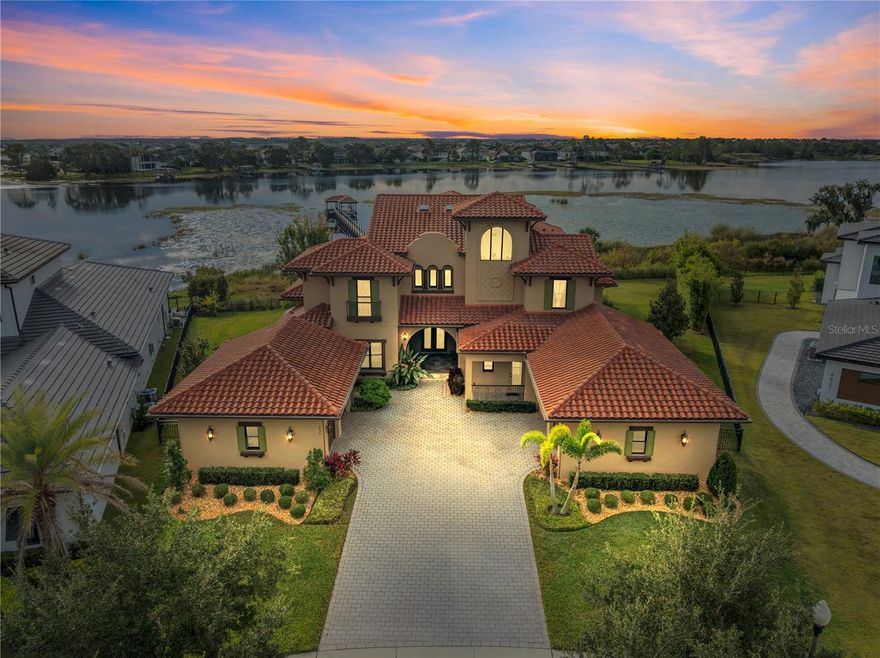 Independence * Exquisite LAKEFRONT home on Lake Hancock so close to Disney you see Disney fireworks ** Prime culdesac location and 1.39 acre pie shaped lot ** 320x4' Trex deck dock (2021) extending all the way from the patio to the covered boathouse w water, electric, powered +/-10x23' boat lift boat & powered double jetski lift (2021) ** 2019 custom home built by Sorenson Construction ** Superb quality finishes w strong attention to detail incl solid wood cabinetry kitchen & baths, laundry room all soft close, crown molding each rm, all 9' solid wood doors, custom closet built ins in all bedrooms & custom closet shelving in the addl closets, wood floors in all main rms except Atrium, custom "Old World Finish" walls & elevator ready ** 30' soaring ceilings w wood beams & Velux skylights in the elaborate Atrium w  a striking double sided precast travertine gas fireplace architectural feature that is also shared w the formal dining rm ** Charming & elegant French Provincial kitchen complete w solid wood cabinetry all soft close, farm style sink, stone counters & generous breakfast area with soothing lake views, tons of natural light and cathedral ceilings ** Expansive mahogany cooking island w natural gas cooktop and all Monogram Advantium kitchen appliances including the built-in refrigerator and built in +/-1 yr old dishwasher included  ** Incredible lake views from the family room offering a well designed tongue & groove tray ceiling with wood beams, built in custom shelving & triple sliding glass doors fully opening to the outstanding outdoor living space ** The Theatre/media room has 2 tiers for seating w floor outlets for seating, a movie screen, built in speakers & all media equipment included ** More lake views from the Game Room w triple sliding glass doors that fully open to the 3 tiered patio ** 1st floor bedroom perfect for an inlaw situation or guest suite w a PRIVATE ENTRANCE offering an ensuite bath & custom walk in closet ** Located upstairs is the primary bedrm featuring a custom designed tray ceiling and a private Juliet balcony with retractable screen & spectacular lake views ** Unbelievable ensuite primary bath featuring a luxurious round soaking tub w stunning ceiling feature above, rounded glass doors in shower displaying an outstanding tile design & custom walk in closet with built in drawers and shelving ** Library/office 2nd floor with french doors & shared wet bar between library & primary bedrm ** Unbelieavable outdoor living offers a resort style heated pool with LED lighting, a 4 seat swimout bar and spa facing the Disney fireworks ** Great ozone pool system and Pentair control ** Outdoor kitchen with grill, electric and water ** Addl features: Anderson double paned windows, 4.5 car garage w/epoxy finish & custom built in attractive storage cabinetry w/shelving system-2.5 car side, electric car charger, 2 entire home water softeners, 1 reverse osmosis in kit wet bar are included, HVAC UV light & dehumidifier +/-2 yrs, auto lights in all closets ** LOW HOA fees $194.69 incl cable & internet + incredible amenities incl 2 commun pools, play areas, a lg commun park plus other neighborhood green space & play areas thru-out neighborhood, loads of sidewalks thru-out community ** Buyer to verify square footage-All rm measuremts approx from Builders flr plan. Bookcases in den/library, TV on back patio, TV in great rm, murphy bed 1st flr bdrm, pool table, refrig in garage, wine refrig, media equipment are incl.