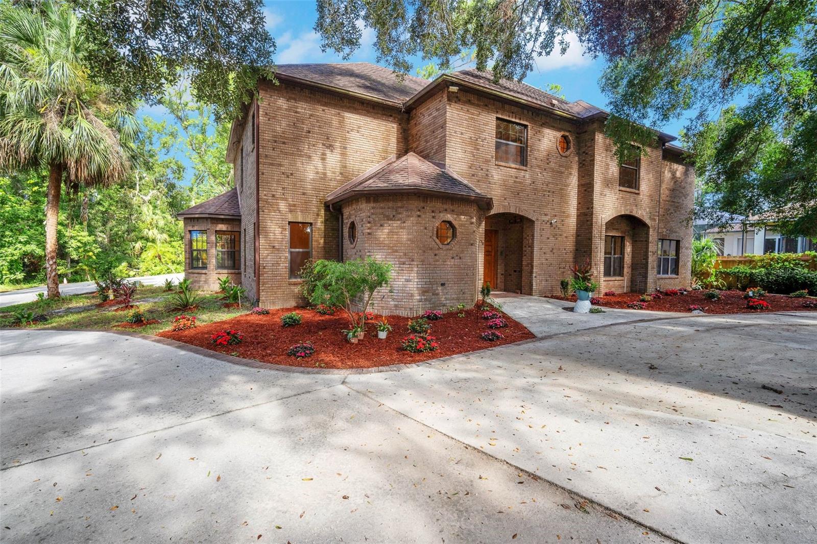 Here is a rare opportunity to own a castle estate on the Alafia River with a 4 car garage, elevator and indoor pool! Step into luxury living with this one-of-a-kind custom-built estate. Nestled at the end of a quiet cul-de-sac and situated on over 1 acre of land, this stunning home offers the perfect blend of privacy, elegance, and resort-style amenities—culminating at the serene banks of the Alafia River, complete with a private dock and newly landscaped riverfront walkway. Inside features rarely found in residential properties: an elevator, indoor heated pool and spa, four-car garage with a custom large workshop, and spacious bedrooms throughout. Recent updates include new kitchen countertops and cooktop, brand-new carpet upstairs, new ceiling fixtures throughout and modern HVAC systems (2022 & 2023). New pool pump and water heaters give peace of mind and comfort for years to come. The first floor features a formal dining room, an elegant living room with views of the gated entrance, and a massive family room complete with a wet bar, fireplace, and two sets of three-panel pocket doors that open to the expansive lanai. Entertain in style with the outdoor summer kitchen, all while enjoying the luxurious indoor pool area, perfect for year-round relaxation. Upstairs, retreat to your primary suite, featuring two large walk-in closets, a spa style bathroom and a private study with a fireplace that opens onto a balcony overlooking the pool. Additional highlights include a guest suite with private bath, a large home office and a convenient upstairs laundry room. This extraordinary home offers luxury, privacy, and unmatched architectural character, all on a picturesque riverfront setting. Don't miss your chance to own this one-of-a-kind estate. Schedule a showing today!