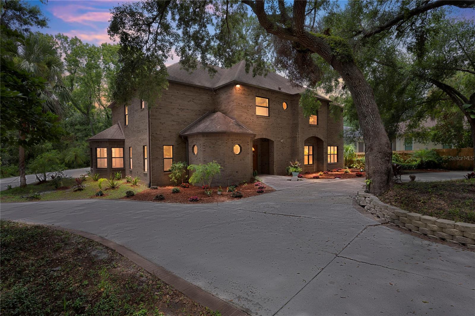 Here is a rare opportunity to own a castle estate on the Alafia River with a 4 car garage, elevator and indoor pool! Step into luxury living with this one-of-a-kind custom-built estate. Nestled at the end of a quiet cul-de-sac and situated on over 1 acre of land, this stunning home offers the perfect blend of privacy, elegance, and resort-style amenities—culminating at the serene banks of the Alafia River, complete with a private dock and newly landscaped riverfront walkway. Inside features rarely found in residential properties: an elevator, indoor heated pool and spa, four-car garage, and spacious bedrooms throughout. Recent updates include new kitchen countertops and cooktop, brand-new carpet upstairs, new ceiling fixtures throughout and modern HVAC systems (2022 & 2023). New pool pump and water heaters give peace of mind and comfort for years to come The first floor features a formal dining room, an elegant living room with views of the gated entrance, and a massive family room complete with a wet bar, fireplace, and two sets of three-panel pocket doors that open to the expansive lanai. Entertain in style with the outdoor summer kitchen, all while enjoying the luxurious indoor pool area, perfect for year-round relaxation. Upstairs, retreat to your primary suite, featuring two large walk-in closets, a spa style bathroom and a private study with fireplace that opens onto a balcony overlooking the pool. Additional highlights include a guest suite with private bath, a large home office and a convenient upstairs laundry room. This extraordinary home offers luxury, privacy, and unmatched architectural character, all on a picturesque riverfront setting. Don't miss your chance to own this one-of-a-kind estate. Schedule a showing today!
