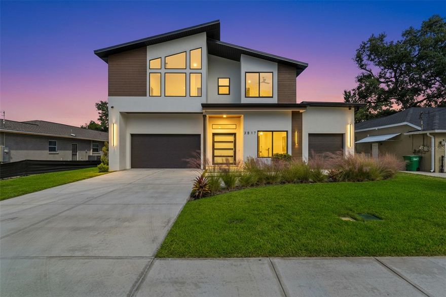 Welcome to 3817 W San Nicholas Street, an exceptional new construction residence by Tafur Construction in the highly coveted Plant High School district. This modern masterpiece offers five bedrooms, four and a half bathrooms, an office, a bonus room, and a three car garage, all thoughtfully designed to blend luxury with comfort and convenience, with no HOA or required flood insurance. 

Step through the gorgeous modern pivot front door and instantly feel the scale of the home. You are greeted by a grand foyer with high ceilings, abundant natural light from large impact rated windows, and an impressive floating staircase with a glass railing and a seating area tucked underneath. The open concept living area features a spacious layout, a decorative accent wall, and seamless flow into the gourmet kitchen.

The chef inspired kitchen is the heart of the home and showcases Thermador appliances, European style cabinetry, elegant quartz countertops, an oversized island with bar seating, exposed shelving, a wine bar, and secret touch lighting controls that create a sleek and futuristic feel. The office with a modern sliding barn door sits at the front of the home and overlooks the quiet street.

This residence offers remarkable flexibility with two primary suites, one on each floor. Both suites include luxurious bathrooms with freestanding tubs, dual vanities, stunning tile work, and spacious walk in closets with built ins. The main upstairs primary suite also features a double shower, and a generous seating area in the bedroom. The best part of the upstairs may be the large private terrace.

The second floor continues to impress with an expansive bonus room that is perfect for a gym, media lounge, playroom, studio, or creative workspace. The natural light in this space is unmatched. A loft area and a well appointed laundry room with built in cabinetry and a sink complete the upstairs layout.

Outdoor living shines in the fully fenced backyard, which is pre plumbed for an outdoor kitchen and ready for a future pool or custom outdoor retreat. Enjoy beautiful T&G wood ceilings on both the front and rear exterior spaces along with a large lot that provides ample room to design your dream outdoor environment.

Additional features include hurricane impact windows, luxurious modern design elements throughout, high ceilings on both levels, a three car garage distributed across two separate garage bays with transom windows, and the quality craftsmanship that defines Tafur Construction. A builder warranty is also included for peace of mind.

Located just minutes from Bayshore Boulevard, Hyde Park Village, Downtown Tampa, and the best dining, shopping, and entertainment South Tampa has to offer, this home delivers an elevated lifestyle in one of the city’s most desirable neighborhoods.