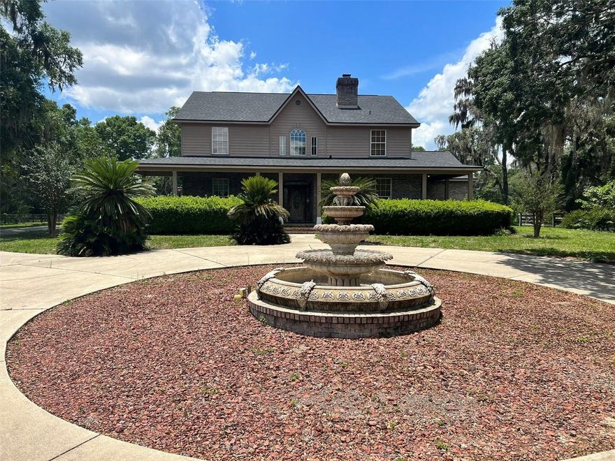 Tucked away at the end of SE 17th Street, this beautifully designed 4-bedroom, 3-bath home offers 12.66 acres of peaceful seclusion in the heart of Ocala. With hardwood floors throughout, a flexible 5th room perfect for an office or guest space, and a spacious 3-car garage, this home combines privacy and convenience. Enjoy Florida living in the unique two-story screened pool area, featuring a spiral staircase that connects the ground-level patio to the second-floor balcony—all within the screen enclosure. Outside, a circular driveway with a fountain leads to a charming covered front porch. Equestrian amenities include a 4-stall barn and a roping arena—ready to be refreshed by the tenant—and ample space for horses or cattle (subject to landlord approval). Small dogs welcome. Pool maintenance included. Property is 4 parcels. Call today to see this luxury hidden gem!