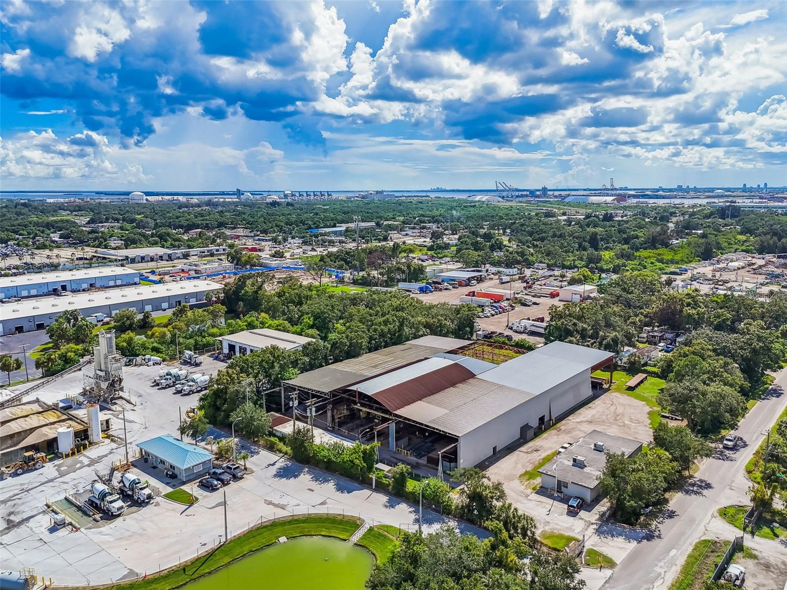 This 2.31 acre fully fenced Manufacturing zoned parcel is currently home to a steel fabrication company. The site contains multiple structures totaling 42,594 SF. The main structure is a large 3 section open bay warehouse with clear heights ranging from 22 to 30 feet with a 5 inch thick slab. There is a 2,080 SF detached office structure at the entrance to the facility which has 6-7 offices, a break area, and a conference room, as well as a warehouse adjacent structure which houses a shop office, shop restrooms and storage. The site also has ample lay down yard for storage and truck access and parking and features multiple 3 phase services.
Business and equipment is available yet not included. Equipment list can be made available upon request and includes a variety of steel fabrication equipment and tooling, plasma cutting table, 1 x 2-ton crane, 1x 3-ton crane and 5x 5-ton cranes and much more.
Located just a few hundred feet east of US-41 (S. 50th Street) in Tampa south of I-4 and the Selmon Expressway and west of I-75, offering easy access to surrounding areas.