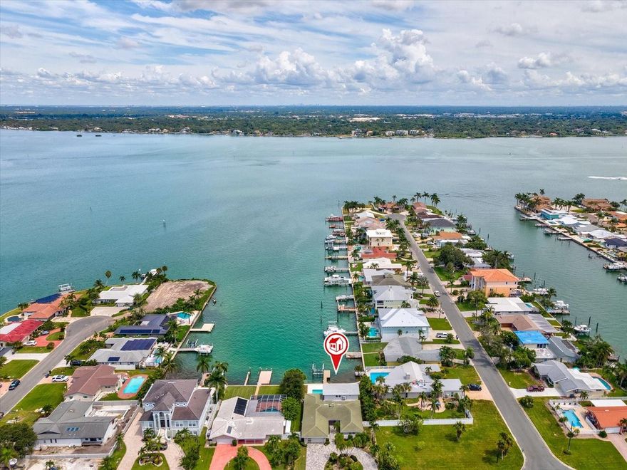 This impressive five-bedroom, three-bath waterfront home embodies the beauty of coastal living. Light-filled interiors open to sweeping water views, complemented by luxury vinyl flooring throughout for a clean, modern look. At the heart of the home, a quartz waterfall island anchors the kitchen, combining style and functionality for both everyday living and entertaining. From multiple rooms, enjoy breathtaking views of the Intracoastal Waterway, creating a serene backdrop to daily life. The home features a spacious primary suite on the main level, along with another large primary suite upstairs, offering flexibility for guests or multi-generational living. The backyard retreat boasts a pool, dock, and boat lift, with endless opportunities to enjoy the water. From your own backyard, watch the pirate ship and dolphin tours cruise by from John’s Pass multiple times a day. With generous bedrooms, thoughtful finishes, and direct access to boating, fishing, and the Gulf, this home offers the best of waterfront living.