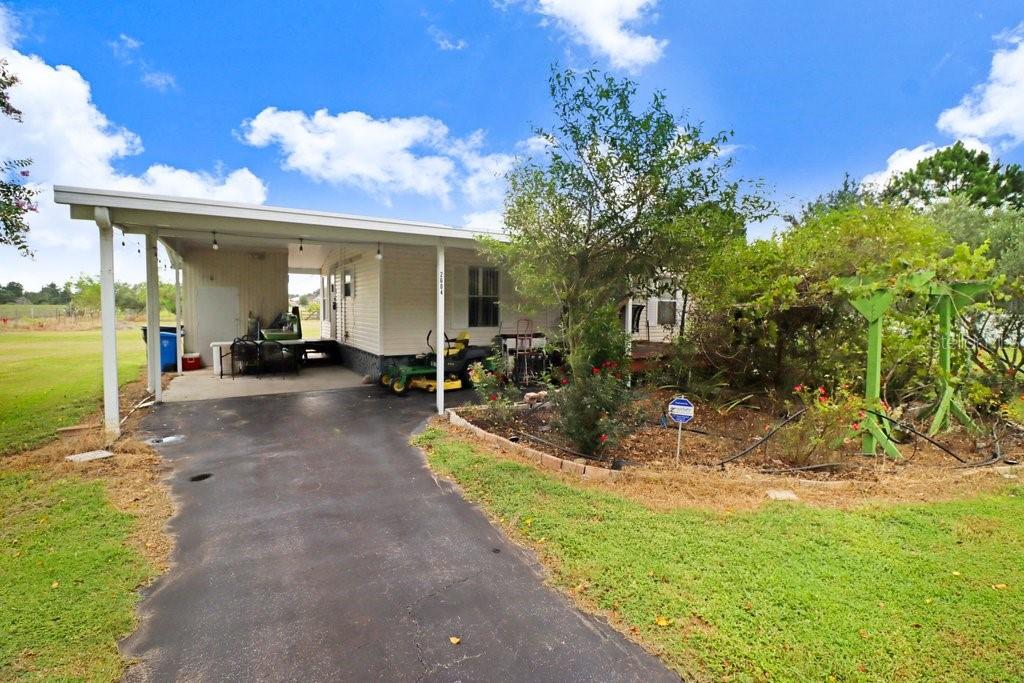 A well-maintained three-bedroom, two-bathroom home situated on a spacious one-acre lot in the desirable Springhead area. The property features include new roof in 2023 as well as newly updated drainage system for the yard, 24x22 metal one-car garage equipped with an electric door opener, along with a small storage shed for added convenience. Additional amenities include a one-car carport with an enclosed laundry room, a 300-foot deep well that requires no water filtration, a concrete parking pad suitable for an RV, an asphalt driveway, sidewalks, and majestic oak trees and numerous fruit trees that enhance the property's charm. List of fruit trees available upon request. The location offers proximity to a park and school, with a short drive to I-4 or Highway 60, providing easy access to both Tampa and Orlando for a convenient commute.