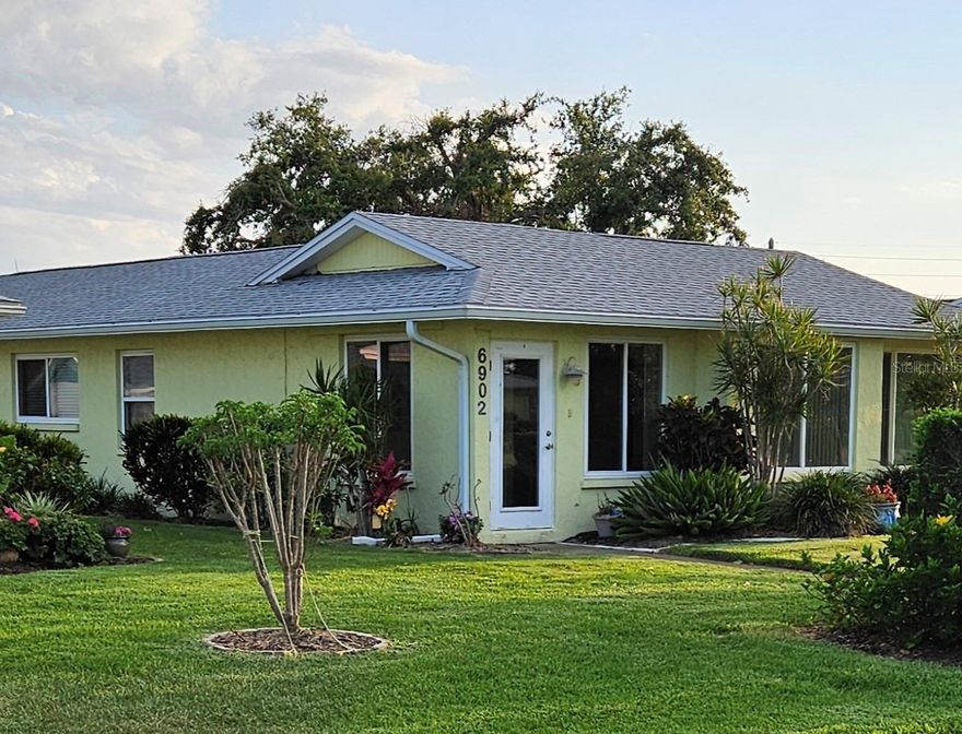Well-maintained and beautifully updated 2-bedroom, 2-bath Florida villa with a 1-car garage, located in the highly desirable Village Green community near Anna Maria Island. This light-filled home offers a modern Florida feel and is in excellent condition, standing out from many comparable villas in the area. The spacious, open-concept kitchen features custom wood cabinetry with soft-close drawers, a tray ceiling with recessed lighting, solid granite countertops, and stainless steel appliances—perfect for both everyday living and entertaining. From the kitchen, you can see the living room, dining area, den, and Florida room, all filled with abundant natural light. High-impact hurricane windows throughout provide exceptional storm protection, energy efficiency, quiet comfort, and peace of mind. Luxury vinyl flooring flows through the main living areas, while porcelain tile accents the bathrooms, office, Florida room, and a large, functional utility room; both generously sized bedrooms are carpeted. Major updates include a new shingle roof (2023) and heat pump A/C (2022). The community pool is just steps away behind the villa and is part of an active, friendly neighborhood where residents enjoy getting together and embracing the Florida lifestyle. Conveniently located near shopping, dining, hospitals, parks, walking trails, and just minutes from the world-famous sandy beaches of Anna Maria Island, this move-in-ready Florida villa is an exceptional opportunity to call home.