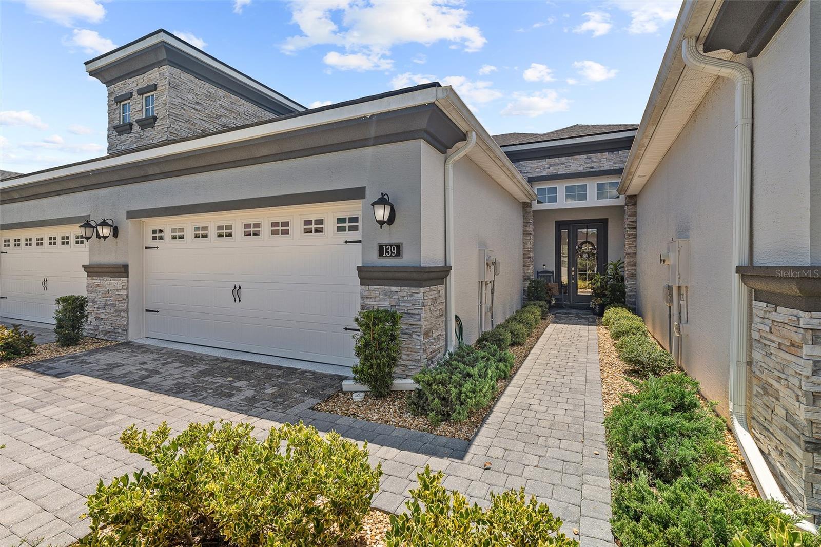 39 Longridge Dr - Townhome Perfection in Plantation Bay! Step into this magazine-worthy townhome that truly shows like a model. Located in the coveted Plantation Bay Golf & Country Club, this home offers a maintenance-free lifestyle and even includes a golf cart so you can fully enjoy the community's resort-style amenities. The Kitchen is a chef's dream with mosaic tile backsplash, LG upgraded appliances (refrigerator features a cocktail round ice maker), 42-inch white soft-close dovetail cabinets, and elegant quartz countertops with a large island overlooking the dining area. The Dining Room features tile floors, a large window with plantation shutters, and a custom light fixture Flows into Family Room that is light and bright with tile floors, accent wallpaper wall, and sliders that open to the lanai for seamless indoor-outdoor living. Into your grand Master Suite you have a double door entry, large windows with plantation shutters, and a spacious walk-in closet. En-suite Master Bath features dual quartz sinks, tile walk-in shower, and private commode room. Guest Bedroom 2 completed with cozy carpet and plantation shutters. Bath 2 has chic wallpaper accent wall, quartz countertop, and tile tub/shower. Head Upstairs to the bonus room carpeted with a tray ceiling, plantation shutters, and a large storage closet. Bedroom 3 feels like a private suite with plantation shutters, abundant natural light, carpet, and a walk-in closet. En Suite Bath 3 ha long quartz vanity, tile flooring, and a walk-in tile shower. Enjoy the floor lifestyle with 1st floor screened lanai with long lake views. Additional Features include Private entry with glass front door, Lanai with large backyard and lake view to the side, laundry room with coastal accents and cabinet storage, 2-car garage with paver driveway, Easy access to the new West Gate entrance, 2 zone Ecobee thermostat. Cruise your included GOLF CART around located in GATED, golf cart friendly community of Plantation Bay. 45 holes of championship golf courses,9 tennis courts,10 pickleball courts, fitness center, spa, 2 pool with cabana bar and grill, walking trails, and new 30 million dollar stunning clubhouse and Prestwick Clubhouse. ASK LISTING AGENT ABOUT SPECIAL SIGNIFICANT DISCOUNT ON INITATION FEE AT THE CLUB!!! Move right in and start enjoying Plantation Bay's unmatched lifestyle in your magazine worthy townhome!