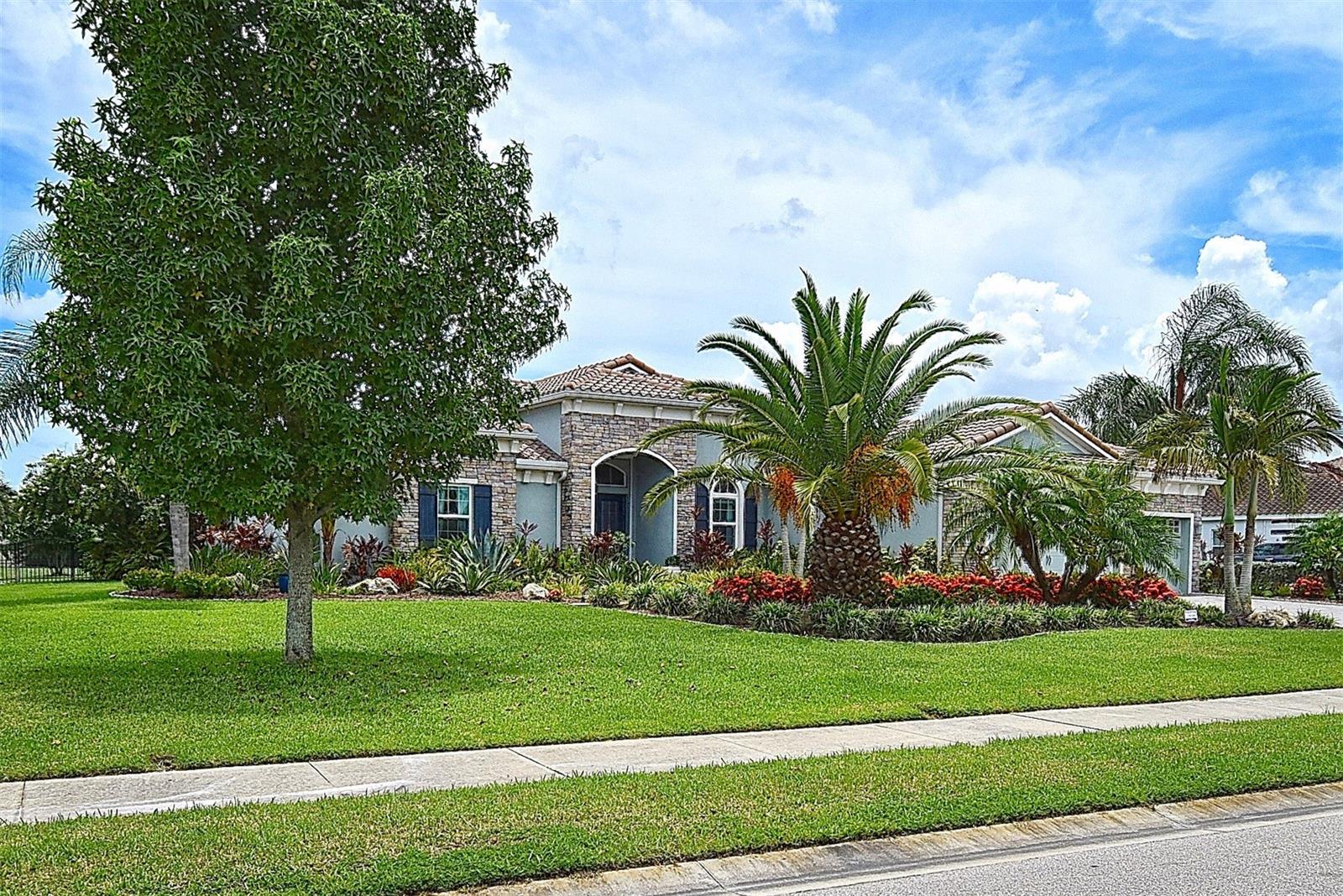 Welcome to 4777 Vasca Drive, an exceptional single-family estate nestled on over one acre of pristine land in Sarasota’s exclusive gated community of Vilano. This meticulously maintained single-story home features 4 bedrooms, 4 full bathrooms, and 3,148 square feet of elegant living space—designed for the Florida lifestyle with seamless indoor-outdoor flow and tranquil water views. Enjoy added peace of mind with impact-resistant windows and exterior doors throughout, along with an automatic hurricane roll-down shutter that provides additional protection for the custom impact-rated front doors.
Inside, the home features a gourmet kitchen outfitted with top-tier appliances, custom cabinetry, granite countertops, and a spacious center island ideal for gatherings. The expansive open layout is flooded with natural light, complemented by coffered ceilings and large windows. Premium finishes such as ceramic tile and engineered hardwood flooring run throughout—there is no carpet in the home. All interior doors have been upgraded to modern solid core doors, adding to the home's refined aesthetic. The luxurious owner’s suite offers privacy glass double entry doors, a spa-inspired bathroom with soaking tub, dual-head shower with bench, double sink vanity, and custom walk-in closets. Guest bedrooms are privately positioned-two with ensuite bathrooms, thanks to a thoughtfully designed split floor plan. Dedicated dining and great room areas, along with flexible spaces, adapt seamlessly to your lifestyle.
Step outside to your private outdoor oasis. A resort-style heated saltwater pool and spa sit beneath a spacious screened enclosure. Enjoy panoramic, unobstructed water views through a picture-frame lanai screen—designed without crossbars to preserve the scenery. The built-in outdoor kitchen, complete with a stainless steel grill, sink, prep station, and refrigerator, makes alfresco dining and entertaining effortless. A large, illuminated, covered lanai provides multiple seating areas for relaxation or social gatherings, all surrounded by lush landscaping, and thoughtfully placed lighting that enhances both privacy and curb appeal.
Additional highlights include an oversized three-car garage with ample room for vehicles, tools, and overhead storage racks. With over an acre of land, you’ll enjoy expansive water views and plenty of space to roam. The Vilano community is known for its estate-sized homesites, quiet atmosphere, and neighborly charm.
Conveniently located just minutes from I-75, UTC Mall, downtown Sarasota, and top-rated schools, this home offers a balance of accessibility and tranquility. World-renowned beaches such as Siesta Key and Lido are just a short drive away, making coastal living a daily reality.
Nature lovers will also appreciate proximity to the Celery Fields—a 400+ acre Sarasota County park and wildlife habitat featuring boardwalks, observation towers, and scenic walking trails. This nearby natural gem is a haven for birdwatchers and outdoor enthusiasts alike.
Don’t miss this rare opportunity to own a luxurious estate with resort-style amenities, peaceful water views, and unparalleled privacy in one of Sarasota’s sought-after gated communities. Schedule your private showing today!