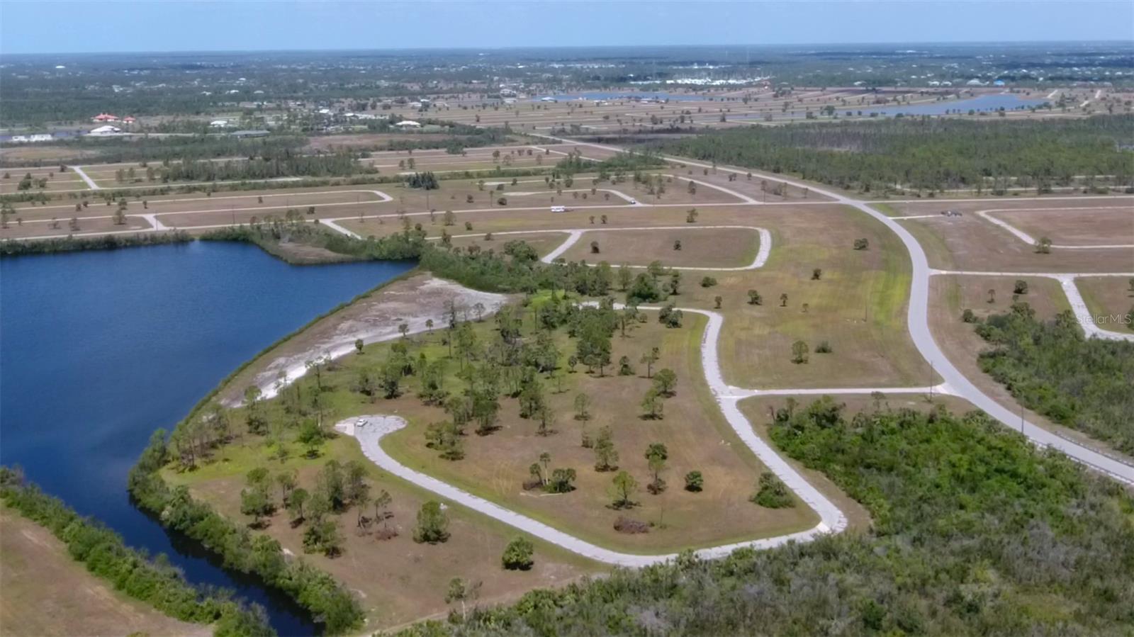 Expansive lakefront acreage site in the heart of the Rotonda Villas in Placida, Florida. The property sits on a pristine lake with amazing sunset views looking west. Property B consists of 2.7+/- acres with over 258 +/- feet of lakefront. Excellent location for a large estate home or multiple homes. Conservation easement runs along the lake and offers a natural habitat/greenspace area. Central water and sewer are available along Harring Way. Power is also available on Harring Way. Property zoning also allows duplexes and multi family development. Low annual HOA fees with architectural guidelines that allow a wide range of construction designs. Docks are allowed on the lake with HOA approval. MSBU in place to re-pave all roads in the subdivision. Schedule has not bee released. Property ID ZZZ 054221 P5 2.7 Acres. This property will be split from the parent tract before closing. Both tracts can be purchased together.