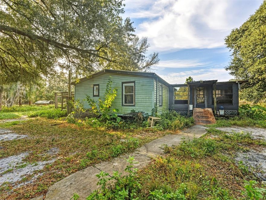 Opportunity filled acreage property located in Polk City offering space, flexibility, and rural charm. Situated on approximately 5 acres, this property features a mobile home with multiple additions along with several sheds and accessory structures. A second mobile home foundation is present, offering potential for future use or replacement, buyer to verify zoning and intended use.

The home includes an open living area, a large enclosed front porch that serves as bonus living space, and a rear porch with a half bath and shower convenient for outdoor use. Portions of the property show unfinished areas and will require some rehabilitation, making this a strong opportunity for investors or buyers looking to renovate and customize.

The land offers a mix of open space and mature trees suitable for animals, storage, or a homestead style lifestyle. Enjoy a quiet rural setting while remaining just minutes from I 4, shopping, and Central Florida attractions. Cash preferred. Seller financing may be available with terms negotiable.