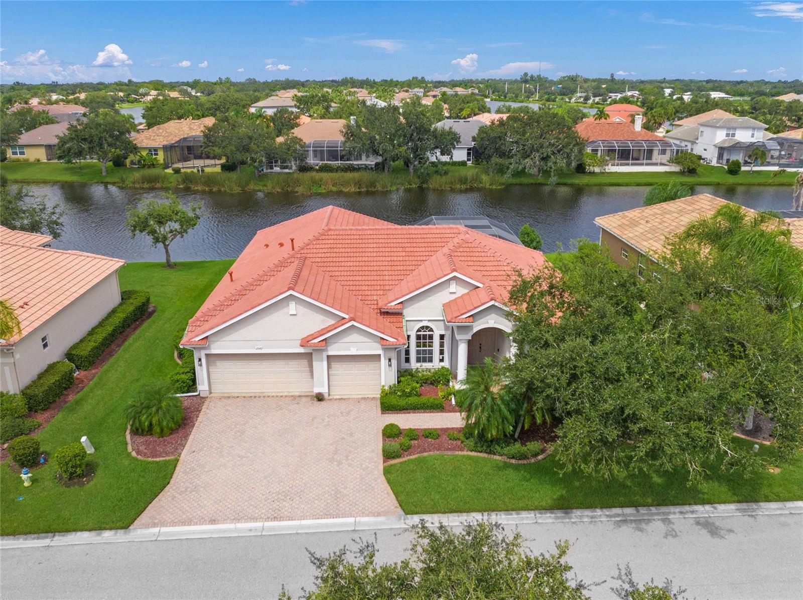SAY HELLO TO A GOOD BUY! * 'A' RATED SCHOOL DISTRICT * TATUM ELEMENTARY SCHOOL IS LESS THAN 2 MILES AWAY * PRIDE OF OWNERSHIP SHOWS * NEW Barrel Tile Roof in JULY 2025 is a $72,000 VALUE * NEW A/C is 1 YEAR YOUNG * NEW Washer & Dryer * The Chef's Kitchen is open to the SPACIOUS Family Room, and features a Kitchen Island, Breakfast Bar & Eat-in Nook * Open the front door to the Formal Living and Dining Rooms * The Primary Suites showcases a Spa-style Bath with Walk-in Closets * FULL HURRICANE COVERAGE - CLEAR, SEE THROUGH PANELS * NEW LUXURY VINYL FLOORING IN THE BEDROOMS INSTALLED BY CHAPPIE'S 2 YEARS AGO * Split Plan Design * Volume Ceilings * Guest Bedrooms & Bath are PRIVATE * The Office/Den/Flex Room COULD EASILY BE A 4TH BEDROOM * All of this wraps your Outdoor Oasis with PANORAMIC LAKE VIEWS * Caged Pool & Spa with an OVERSIZED LANAI that has 2 separate Covered areas * This is the perfect setting for entertaining with family & friends and for relaxing in your slice of paradise *
Irrigation System with Reclaimed Water * RARELY AVAILABLE in GATED LAUREL LAKES * Amenities include: Clubhouse, Fitness Center, Pickleball Courts, Community Pool and LOW HOA fees * NO CDD * Country feel yet minutes to Siesta Key Beach, shopping & dining, EXCELLENT A-RATED SCHOOLS, Rothenbach Park, and the new Publix shopping plaza is just 5 minutes away * One look & you'll fall in love with this immaculate home * GATE CODE REQUIRED FOR SHOWINGS *
