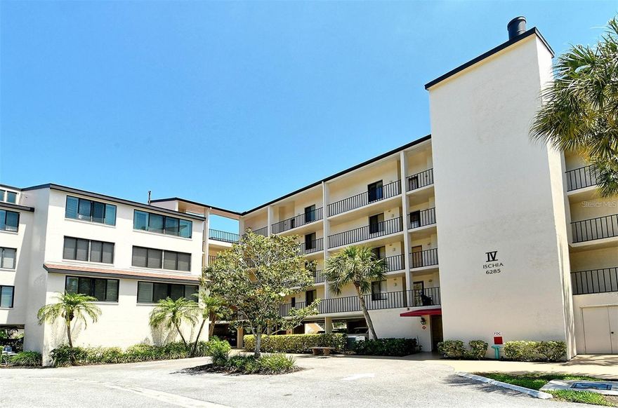 MAJOR PRICE REDUCTION!! Welcome to this 4th floor/Penthouse condo for sale at the Excelsior Bayside Complex. Coveted for its soaring ceilings and the opportunity to add an upper 3rd bedroom, years can pass without one becoming available. This particular unit faces south and is filled with natural light with the added benefit of clerestory windows. New AC and water heater in 2025. A pre-listing home inspection was conducted for your peace of mind and is available for review.  There have been some upgrades over the years and the condo has been owned by the same family since construction. Smoke free, never rented, and this well maintained unit is ready for cosmetics here and there, or  renovate and add hundreds of square footage amid the endless possibilities. The screened in lanai  overlooks the grounds and has a bird's eye view of the bay.  Each condo comes with assigned underbuilding parking and locked storage for your toys and seasonals. Absolutely the best value and opportunity on the market

The Excelsior is rich with amenities: Two Large Heated Swimming Pools, Poolside Restrooms / Hot Water Showers, Two Hot tubs, Tennis Courts,  Pickle Ball Courts, Fitness Center, Gulfside Sun Deck, Beach Lounge Chairs, Outdoor Grills, Intercoastal Fishing Pier, Community Room and monthly community events, Library, and catering kitchen. Walk to Shopping, Dining, Bike & Boat Rentals
  This ideal location on the key has direct and deeded beach access to Siesta Beach, renowned for its quartz sand known for staying cool in the summer and feels like talcum underfoot.  Easy on and off the key access at  the south Stickney Point Bridge. The increasingly popular Gulf Gate  neighborhood is just over the bridge offering a wide variety of eclectic restaurants, grocers, pubs, and shops. 
A remarkable opportunity with these features and at this price which doesn't come around very often. 
Please note that many of the grounds photos were taken prior to last year's storms. Landscaping restoration is still in process.