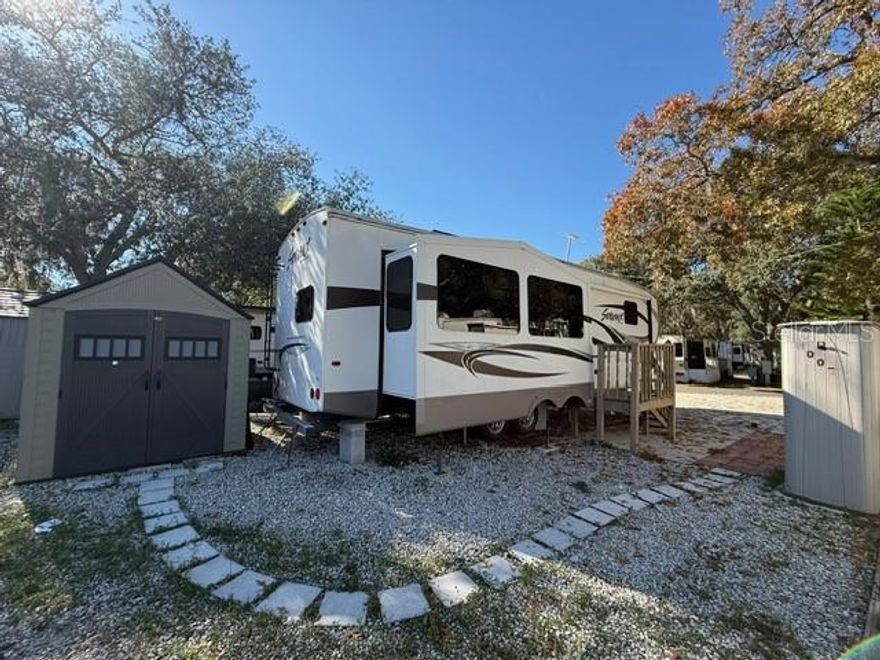 Spacious 2014 One bedroom with one bathroom 5th Recreational Vehicle on private lot. Tons of cabinet space, built-in furnishing, just bring your toothbrush! Utility shed and a patio area perfect for outdoor relaxation with an outside lounging area perfect for a barbecue. The park amenities include an Olympic-size swimming pool, shuffleboard courts, basketball, putt-putt golf, and much more! With a private owner on-site store for convenience grocery shopping and a restaurant inside with made to order breakfast, lunch and dinner. Conveniently located near Orlando's attractions, this property offers easy access to the 429 and 414 for a smooth commute. Your monthly rent covers water, sewer, trash pickup, and a security gatehouse. Located close to shopping, hospital and outstanding restaurants. The RV can be purchased cash payments to be determined by Owner.