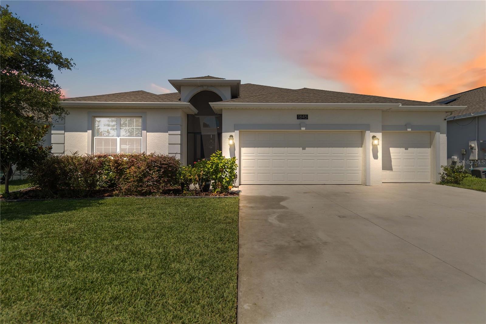 Mortgage savings may be available for buyers of this listing. Welcome to this beautifully crafted 4-bedroom, 3-bathroom home in the desirable Trinity Lakes community. Built in 2023, this spacious 2,621 sq. ft. property offers the perfect blend of comfort, style, and functionality. Step inside to find an open floorplan with high-quality tile flooring throughout the main living areas and soft carpet in the bedrooms. Just off the entry, a formal dining room offers flexible space that could easily serve as an additional sitting area or home office. The living room features soaring vaulted ceilings and a sliding glass door that opens to a screened-in lanai—perfect for enjoying Florida’s indoor-outdoor lifestyle. The kitchen is a standout with sleek stainless steel appliances, a center island with seating, and plenty of cabinetry. The primary suite is tucked away for privacy and includes its own sliding glass door to the lanai, a large walk-in closet, and an en suite bath with dual sinks and an oversized walk-in shower. Additional highlights include a spacious 3-car garage and modern finishes throughout. Trinity Lakes offers residents access to a resort-style pool, clubhouse, and fitness center. Located near beautiful lakes, with quick access to major highways, and just a short drive to downtown Orlando, this home combines convenience and comfort in a growing community. Don’t miss your chance to own a move-in ready home that checks all the boxes.