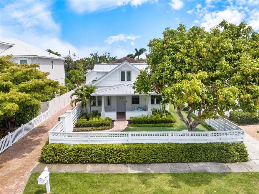 One or more photo(s) has been virtually staged. Live the ultimate Southside Village lifestyle in this one-of-a-kind Craftsman-style home, where charm meets everyday convenience in a rare blend of elegance, craftsmanship, and modern sophistication. Rebuilt to current code in 2014, it offers the refined feel of a coastal farmhouse, with every detail thoughtfully designed for comfort, efficiency, and timeless appeal nestled in one of Sarasota’s most sought-after and walkable neighborhoods. Step through the privacy gates into a lush, fully fenced yard where a rich paver brick driveway, terrace, and walkways guide you through a serene, low-maintenance garden. Featuring artificial turf, vibrant flowering shrubs, and fruit trees, the exterior is not only incredibly private but also immaculately maintained for effortless enjoyment. Every inch of the property has been meticulously manicured, a true testament to the care it has received. Inside, the floor plan strikes the perfect balance between open living and intimate gathering spaces, ideal for both entertaining and everyday living. The kitchen and living room connect seamlessly, creating a warm, functional flow perfect for hosting or simply relaxing at home. The first-floor primary suite is spacious and secluded, featuring his and hers walk-in closets, dual vanities, and a large walk-in shower, a true retreat within the home. Also on the main level is a sun-filled bedroom that offers wonderful flexibility: perfect as a guest room, home office, or children’s playroom. Upstairs in the main house, you'll find an additional bedroom and a generously sized flex space that is ideal for a game room, entertainment room, or home gym, depending on your needs. The detached two-car garage adds both function and charm, offering an upstairs guest suite complete with a full bath, wet bar, and mini-fridge that is greatly suitable for visitors, a private studio, or a quiet home office. This home truly looks like it belongs on the cover of Southern Living or Coastal Living magazine, thanks to its effortless blend of style, warmth, and timeless appeal. Tucked away on one of Sarasota’s most beloved streets, you're just steps from Morton’s Market, Libby’s, and other neighborhood favorites. Located in the highly regarded Southside Elementary School district, the home offers the very best of the West of Trail lifestyle, walkable to restaurants, boutique shops, and Sarasota Memorial Hospital, with easy bike access to downtown Sarasota, St. Armands Circle, and our world-famous beaches.