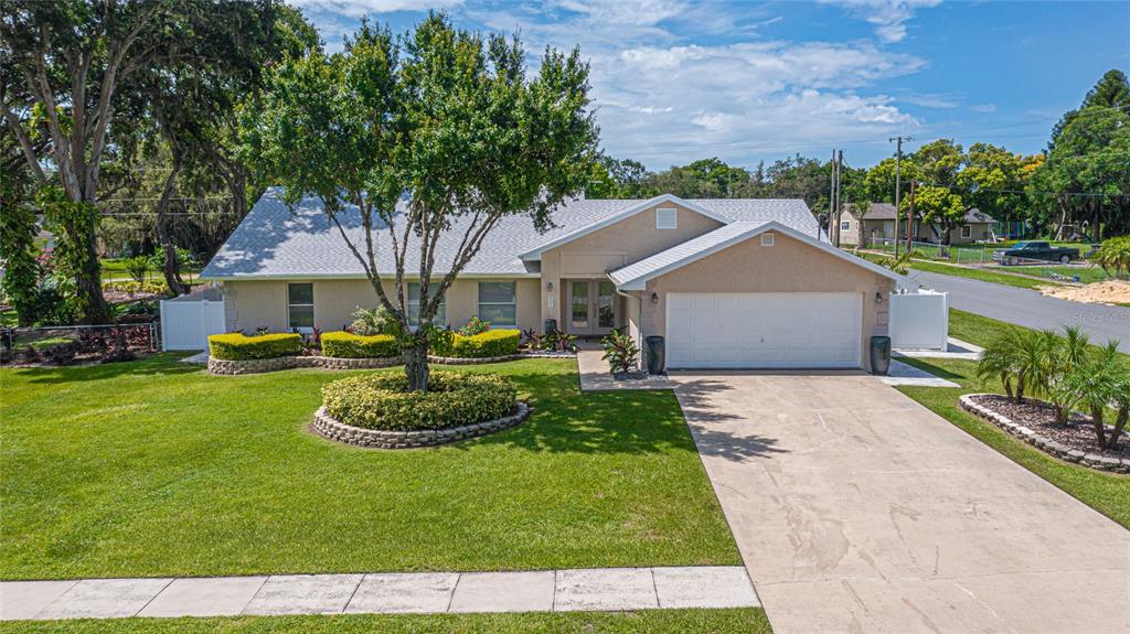 Just Reduced.. Price TO SELL & MOVE IN Ready!! *NEW ROOF & NEW PAINT in 2020* NO HOA!! Welcome home to this corner immaculate Davenport gem on a large fenced .38 acre lot with tons of upgrades throughout. As you drive up to the home, right away, you notice the fantastic curb appeal. Meticulously groomed landscaping, paver walkway leading up to the covered entry and large driveway in the garage. Talk about space; there are the main house, an attached garage. The open layout of the formal living room features a beautiful brick fireplace with built-in shelving. The spacious living room and dining room make it perfect for entertainment plus the immaculate condition of the kitchen with stainless steel appliances. To the left side of the house, retreat to the large master suite with an awesome walk-in closet and large ensuite FULLY RENOVATED bathroom. On the other side of the house, there are two spacious bedrooms with a gorgeous renovated bathroom. The interior laundry room is just off the garage for your convenience. *Extra feature* Whip up your favorite meals in the beautiful summer FULL PATIO KITCHEN with gas stove, smooth GRANITE counters, recessed cabinetry, stainless steel refrigerator and for great summer gatherings by the SALT SYSTEM POOL and HUGE backyard. Additional features include modern laminate flooring throughout the entire house, high ceilings and contemporary lighting. Enjoy lounging on the giant, screened enclosed patio with salt water pool. There is an irrigation system that runs off of well water. Plenty of nearby shopping, entertainment, dining and just minutes away from Highway 17 & 27. Truly a must-see home and will not disappoint. Schedule your showing today, will not last long!