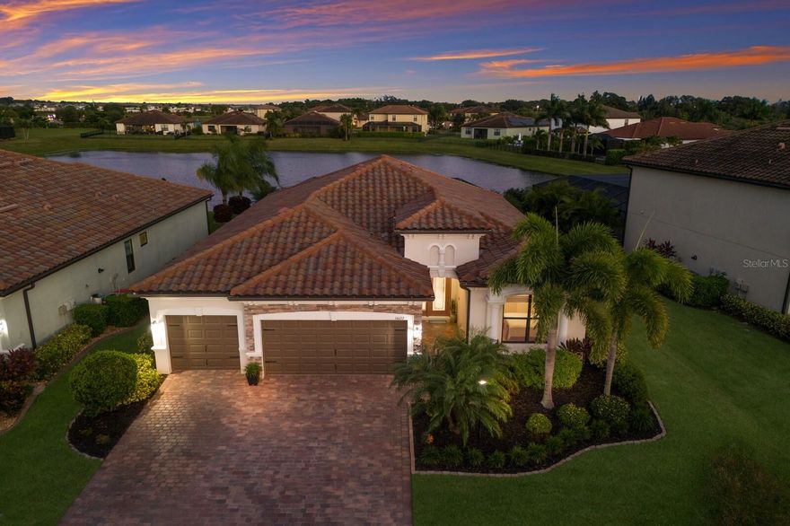 WELCOME to this STUNNING Princeton II model by Lennar featuring 4 bedrooms, 2 baths, and a 3 car garage, located in the highly sought after community of Savanna in Lakewood Ranch. As you enter through the ELEGANT front door, you are greeted by a SPACIOUS open floor plan and a FORMAL dining area that flows seamlessly into the large great room. The living area features a tray ceiling, a CUSTOM built-in electric fireplace with shelving and cabinetry, and glass sliders that open to your peaceful lanai making it perfect for COZY nights or relaxing with family. The kitchen is BEAUTIFULLY designed with stainless steel appliances, a tile backsplash, granite countertops, and a large island with a sink which is ideal for entertaining guests. It also includes a REVERSE OSMOSIS WATER FILTRATION SYSTEM under the sink and a separate casual dining area with glass doors and windows overlooking the sparkling pool. The PRIVATE primary suite offers tranquil views of the pool and pond, with its own lanai access through a glass door. This RETREAT features a tray ceiling, a CUSTOM walk-in closet system, and an ensuite bath complete with dual sinks, granite countertops, a garden tub, and a walk-in glass tiled shower. On the opposite end of the home, three additional bedrooms and a full bathroom with a tub/shower combo provide plenty of space for family and guests. Step outside into your own outdoor OASIS featuring a custom HEATED SALTWATER POOL and SPA with an automatic in-floor cleaning system. The Hayward pool equipment includes remote controls for easy operation. The pool pump was recently replaced, and the salt cell was updated in 2024. The screened lanai is surrounded by LUSH landscaping and overlooks a serene pond, creating the perfect backdrop for entertaining or simply enjoying the Florida sunsets. This home is loaded with upgrades, including a WHOLE-HOUSE WATER SOFTENER, Wi-Fi compatible LG refrigerator and Bosch dishwasher, CROWN MOLDING throughout, LUXURY VINYL plank flooring in all bedrooms, UPGRADED lighting and remote controlled ceiling fans, Hunter Douglas motorized shade on the sliding doors, a custom BUILT-IN office workspace with additional storage, smart home features such as Wi-Fi front door lock and camera, thermostat, and Ethernet connections in bedrooms, office, and family room, an AC PURIFICATION system with dual GERMICIDAL UV lights, and an overhead storage rack in the 3 car garage. This METICULOUSLY maintained home is truly move-in ready, combining comfort, style, and modern functionality in one perfect package. Savanna is a fabulous community with LOW HOA resort-style amenities such as a clubhouse, swimming pool, state-of-the-art fitness center, basketball courts, playground, dog park and numerous walking paths. Lakewood Ranch is known for their A+ rated school system and is perfectly located just a short ride to downtown Sarasota, St. Pete, world class shopping, fine dining and the FAMOUS Gulf beaches! Don't wait to make this your home and begin your FLORIDA Lifestyle!