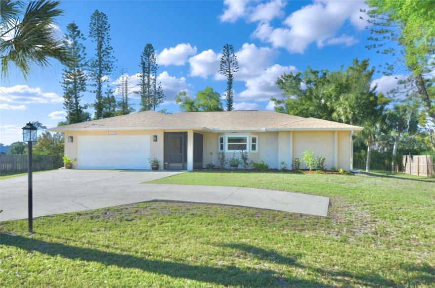 Set on a generous 0.72-acre lot, this home presents a refined Englewood retreat that blends thoughtful design with relaxed coastal living, just about a mile from the shoreline of Manasota Key Beach. This 3 bedroom, 2 bathroom residence delivers bright volume and clean lines, enhanced by cathedral ceilings, recessed lighting, and a crisp mix of tile flooring throughout the main areas, with LVP adding comfort to the primary suite. Hurricane impact windows and doors (2024) provide a strong, finished feel, while the 2022 roof supports long-term confidence. At the heart of the home, the kitchen stands out for craftsmanship and detail. All-wood cabinetry includes soft-close features and toe-kick drawers for streamlined storage. Granite countertops pair with stainless steel appliances, skylights, a pot filler over the stove, and a double oven, ideal for everyday meals or special occasions. Pass-through openings connect to the front living room, keeping the layout open and social. For additional organization, separate storage cabinetry topped with quartz countertops adds extra room for pantry items just off the kitchen. A split-bedroom floor plan enhances privacy, with the primary suite positioned as a comfortable destination. Enjoy a dedicated sitting area, sliders to the patio, built-in closet storage, and an en suite bath featuring dual sinks, a walk-in shower with built-in shelf, and a walk-in closet. Step outside to a covered lanai with ceiling fan, then continue onto the extended pavered patio, overlooking a wide, open backyard with a tranquil wooded view. With a 2-car garage and close proximity to dining, shopping, grocery, golf, and parks, this home offers space, updates, and a calm setting in one complete package. Don't miss this opportunity to experience the incredible Florida lifestyle!