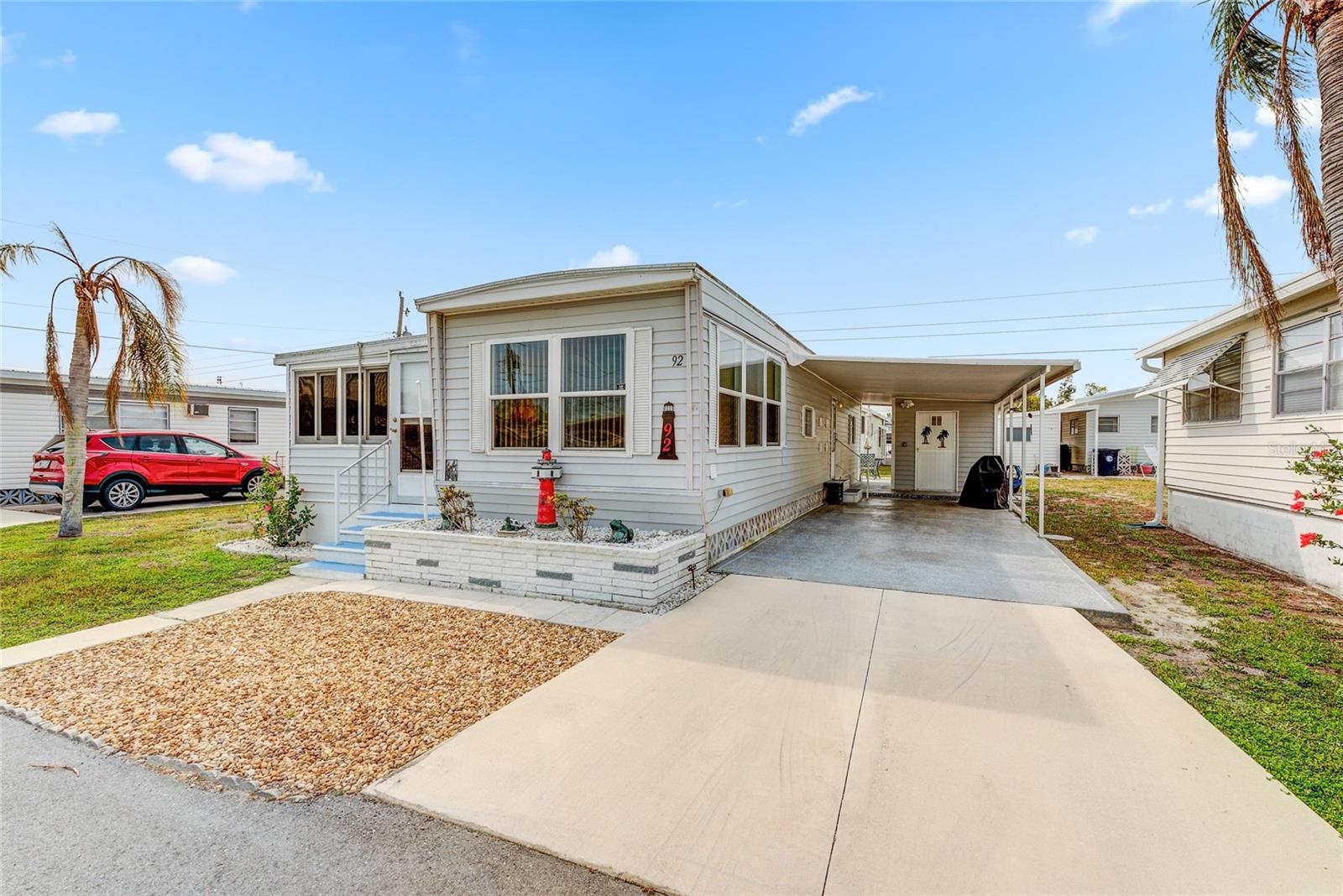 Welcome to Tropic Isles, a stunning 55+ cooperative community located directly on Terra Ceia Bay with direct access to Tampa Bay and the Gulf of Mexico! This is the premier park for anyone who loves the water, with boat slips, a boat ramp, and even a marina available! This vintage charmer on Del Rio is fully furnished and ready for its new owners! You'll find the main living space to be open, with the living room, dinette, and kitchen flowing together into one living space. The cross-beams in the living room are actually lights, bringing in even more light to the home (this home already gets plenty of natural light). The Florida room is ducted, and is currently being used as a second bedroom / flex space. The bathroom features a tub/shower combo, and the primary bedroom at the rear of the home has no shortage of closet and storage space! Outside you will find a storage shed with the washer and dryer, and there is a lovely patio out back! This community is PET FRIENDLY and amenity-rich, with features including a waterfront clubhouse, swimming pool, fitness, shuffleboard, and more! Most items will remain in the home, but the seller will need to remove some personal and decor items prior to closing. Schedule your showing today!