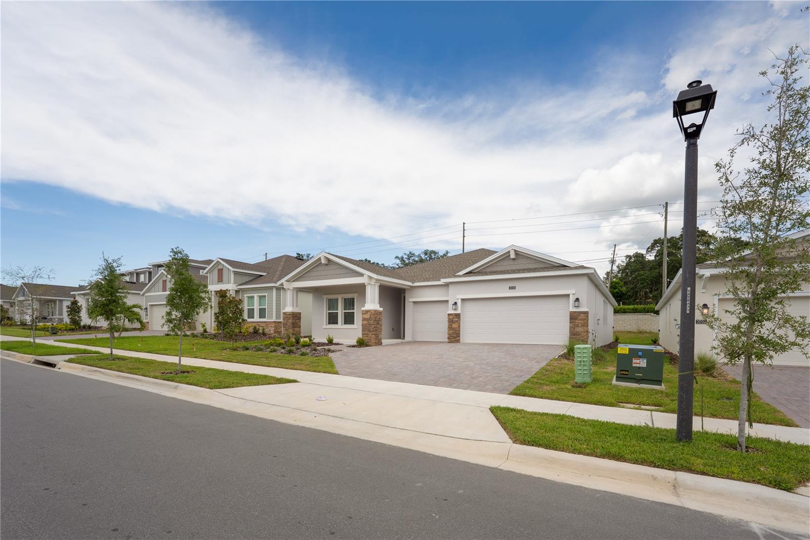 A charming, newly built single-story home in the Bronson’s Ridge community, modern open-concept living across 2,387 square feet, featuring 4 bedrooms and 3 full baths. The heart of the home is its seamless flow between the kitchen, family room, and both casual and formal dining areas, naturally extending to a delightful lanai through sliding glass doors—perfect for enjoying Florida’s sunshine. The primary suite is a serene retreat with a spa-style bathroom, while the three secondary bedrooms are thoughtfully placed on the opposite side for extra privacy.