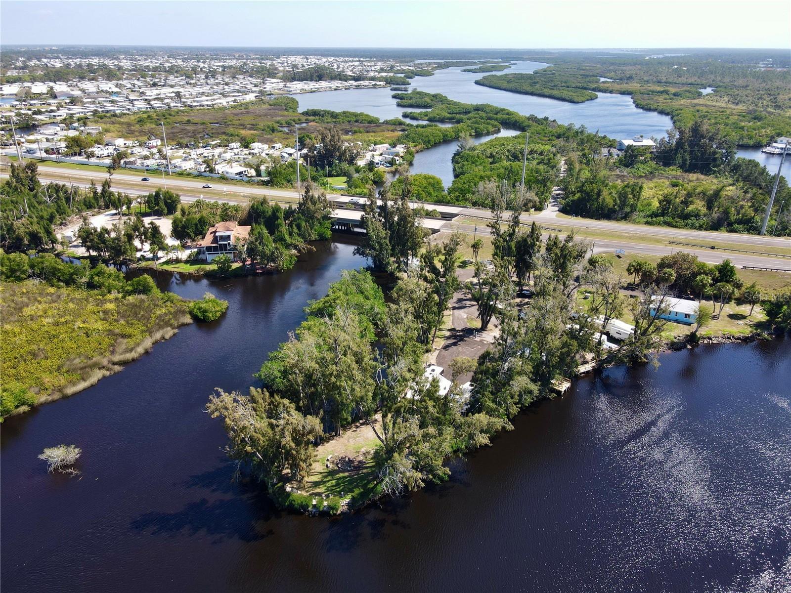 Great opportunity to own your very own 1.26 acre peninsula with approximately 400 ft of frontage on US 41 and over 900 ft of frontage on the Myakka River. Truly a one-of-a-kind property with beautiful panoramic views. Currently being used as a RV Resort. Property features 12 RV spots with its own individual electric meter, water and waste lines along with a duplex apartment. The water system is well water, and Septic tank for waste lines. Duplex building has 1 bed 1 bed, recently renovated with new hurricane impact windows, New roof, New kitchen and granite. Also featuring a common area/utility building that has two separate restrooms, each with showers, and laundry room on the premises. Each RV space and duplex all have brand new water mains and backflow preventers going to each space. Brand new reverse osmosis system with brand new equipment such as pumps and water softener. Park just had new asphalt throughout. Take the Myakka River out to the Gulf of Mexico. Five-minute drive to the Braves Spring training located in Wellen Park. Walking distance right to the Myakka River Oyster Bar and Seafood Restaurant. Close to Englewood, Manasota, and Venice Beach. Sarasota Memorial Hospital is breaking ground for a new facility just North on Route 41 along with a New Costco. FINANCING AVAILABLE