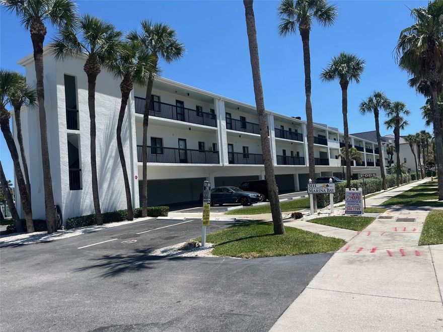Sun-drenched end unit with prime waterfront views! This elevated residence features a seamless open floor plan overlooking your private boat slip. Enjoy modern tile flooring throughout, beautifully upgraded walk-in showers, and the convenience of inside laundry. Resort-style living at its best with a heated pool, private beach access, three assigned parking spaces, and a garage.