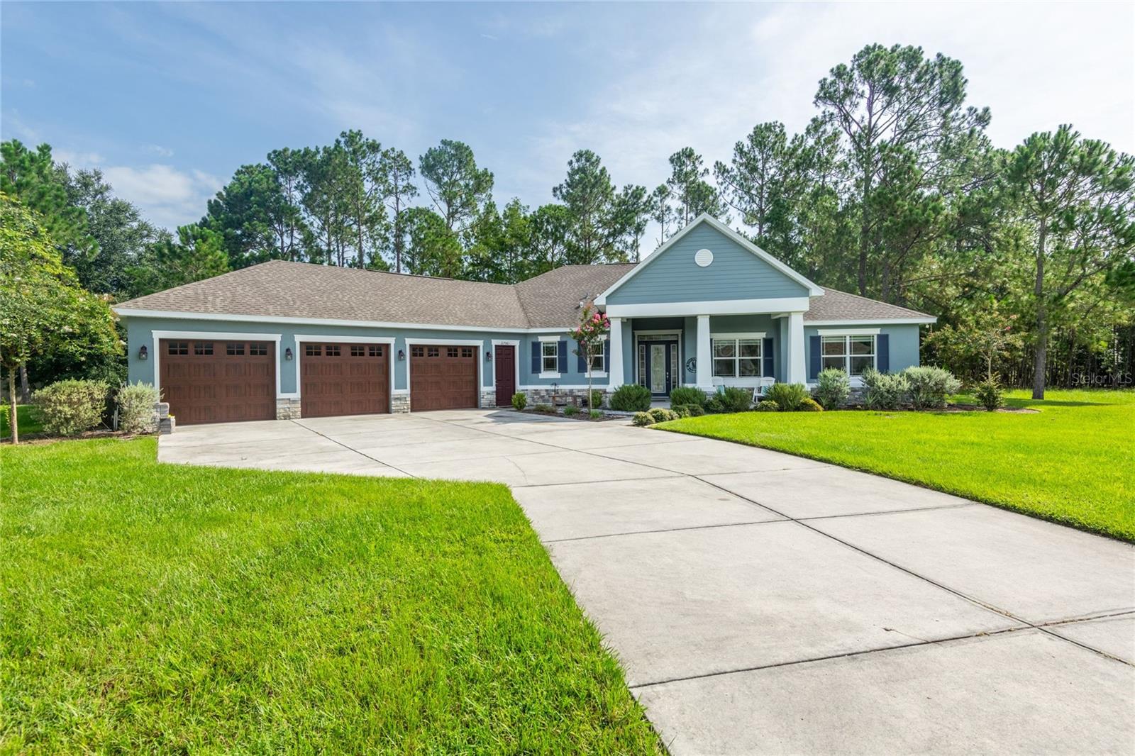 This Custom home was built in 2017 and features 3 bedrooms, 2 and a half bath, on a 2.62-acre lot. You will love the curb appeal when you pull up to this home with the craftsman style architecture, front porch and the decorative glass door. As you step into the foyer, you are greeted by the large open floorplan with the high ceilings and windows bringing in lots of natural light. The gourmet kitchen features a large granite island with seating along with a dinette area and large walk-in pantry. The 42-inch wood cabinets have soft close drawers and cabinets. The refrigerator and dishwasher were replaced a few months ago and a reverse osmosis system was added to the kitchen sink. With the dinette area off the kitchen in addition to the seating around the kitchen island there is a lot of room for entertaining with friends and family. Also located off the kitchen is a half bath and a large laundry room. The split floor plan separates the primary bedroom from the secondary bedrooms. The primary bedroom boasts an oversized picture window overlooking the private preserve area in the back of the home. The ensuite bathroom has a large vanity with double sinks, large soaking garden tub, a large shower and toilet nook along with a large walk-in closet with custom shelving. On the other side of the home, you will find the oversized secondary bedrooms which share a jack-and-jill bathroom with dual sinks and lots of storage. The large living room has recessed sliding glass doors that allow you to overlook the quiet, peaceful beautiful backyard and the screened lanai. You will love the lanai with the tongue and groove ceiling and new ceiling fans with space to grill and entertain in the fully fenced backyard with a fire pit. This home also has an oversized 3-car garage and one of the bays has a pull-through with another door on the adjacent wall. Recent UPGRADES include the Epoxy on the garage floor, New Carpet in the bedrooms, Rachio Sprinkler System, MyQ Garage Door openers, New Water Softener, New Heat Pump Water Heater, Septic has been recently pumped and a New Pump and Panel with an Alarm was added, New Can Lights throughout the great room, kitchen and dining, New outside lighting, and 2 New Ceiling fans inside. In the peaceful gated horse community of Westwood Estates, you will spot wildlife such as deer, wild turkey and other abundant wildlife that roam freely. This community is located less than 10 minutes away from the popular Groves Shopping Center, as well as dining, shopping, and easy access to highways. Do not miss a chance to call this home!
