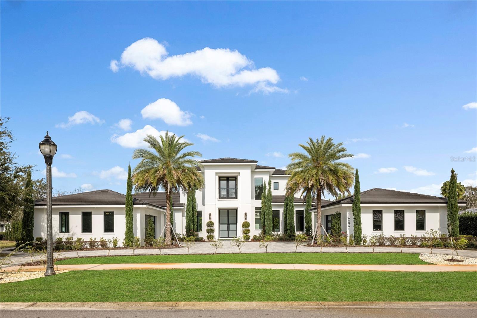 This one of a kind beautiful transitional-style home built by Element Homes with an open floorplan in the exclusive gated community of Chaine Du Lac on 1.2 acres. As you enter through the 10ft custom steel doors you will be welcomed by a huge great room and a line of sliding doors that pull your eyes directly the pool and gorgeous expansive and private back yard. Entering the kitchen, you will notice top of the line Sub-Zero fridge and Wolf appliances with double oven, 6 burner cooktop and griddle, pot filler, drawer microwave and 2 gorgeous quartz wrapped islands. Multiple entertaining areas starting with the first-floor game room overlooking the covered lanai and pool area through your 90-degree sliders. Entertaining friends and family for the big game or movie night then the theater will certainly satisfy with top-of-the-line home theater equipment and a 120-inch screen. The home is also on Crestron smart system audio/video, lighting and shades. Music is controlled throughout the home by a Sonos system. The covered porch offers plenty of space for entertaining also and a summer kitchen, sitting bar and outdoor fireplace. The summer kitchen offers a wolf grill, dishwasher, and ice machine for those endless parties. The pool has been outfitted with a spa, splash pad, and a sunken down fire pit for those cooler Florida nights. This house also offers a detached guest suite that can be utilized by a nanny or in-laws. The master suite has a breakfast bar and beautiful feature wall that you must see to appreciate. Completing the master suite is a large walk-in closet and bath with shower body jets, rain head, free standing tub and an outdoor shower to enjoy the wonderful Florida weather. On the second floor, you will find 3 large bedrooms with walk-in closets and ensuites in each. You also have a loft area for gaming, studying and entertainment. There is a a secondary laundry area upstairs. The main laundry area downstairs offers ample size and a dog wash shower. On the side of the home the owners have added a Zen Garden complete with a sauna. An outdoor mosquito misting system is in place for worry free outdoor enjoyment. The home is also equipped with a whole home generator.